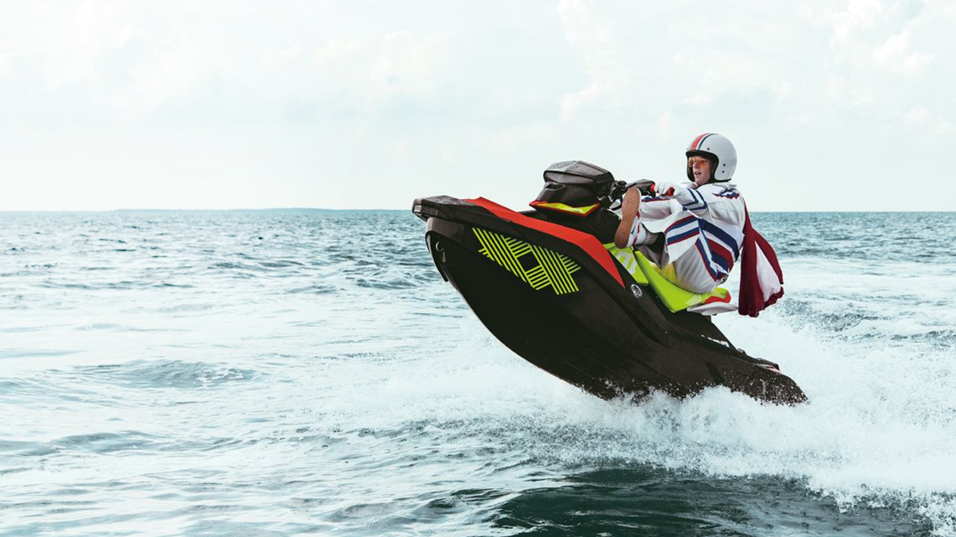 A costumed man is doing tricks in the water with his Spark Trixx