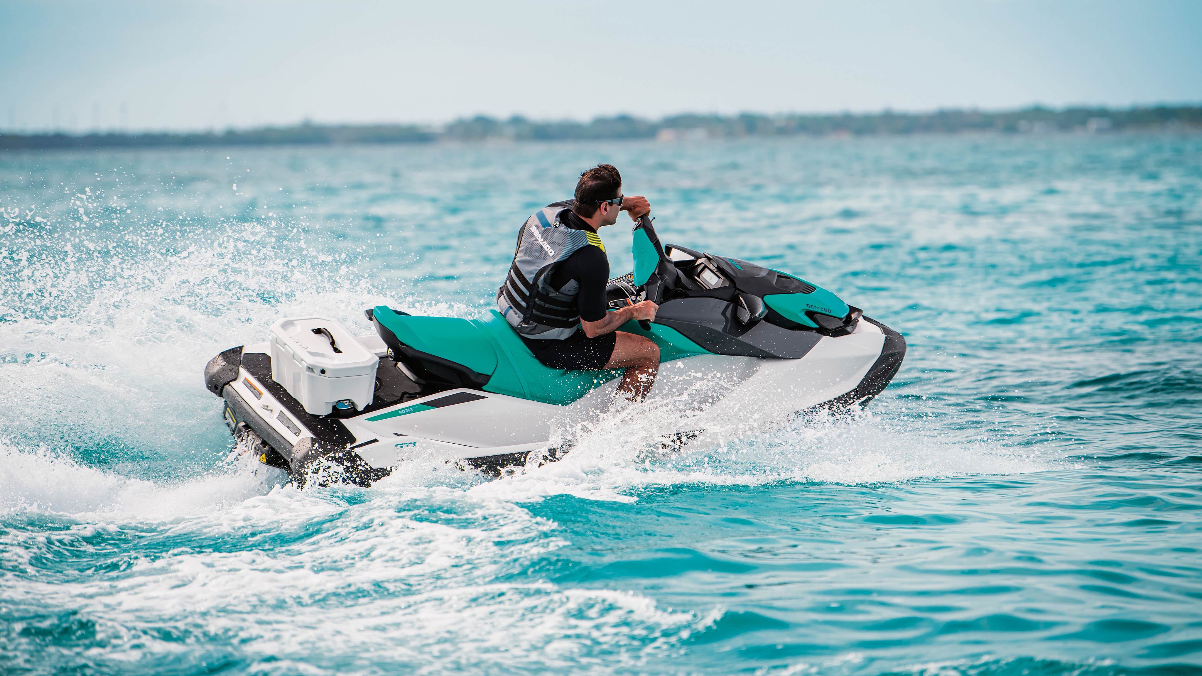 Man riding a Sea-Doo GTI with a LINQ rear cargo box