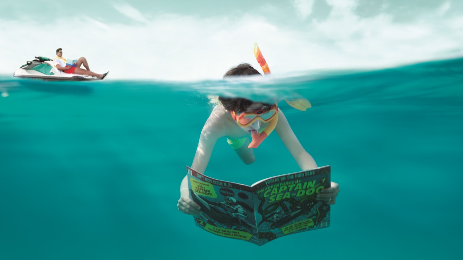 A young kid reading an edition of Captain Sea-Doo underwater