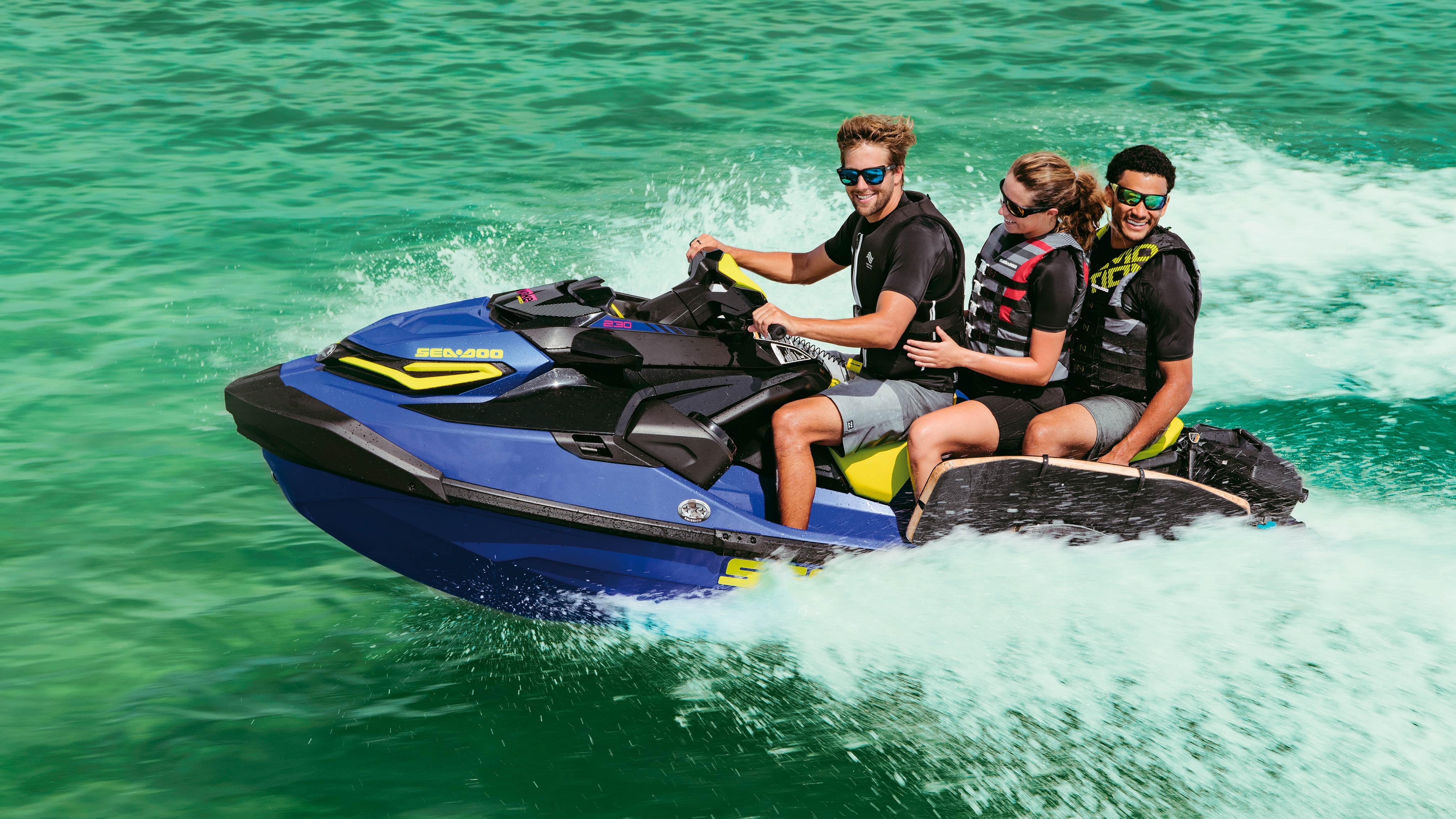 Group of three riding a Sea-Doo Wake Pro. 