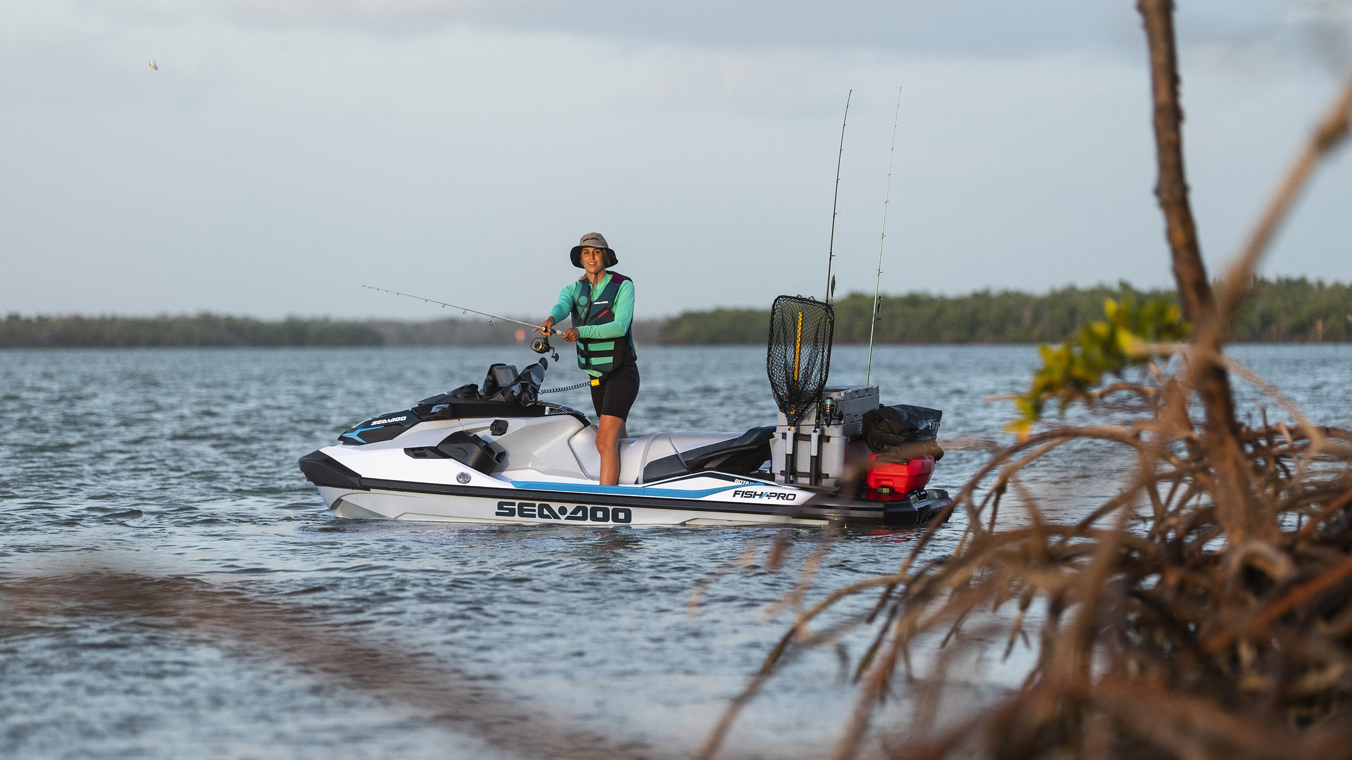 Woman fishing on her Sea-Doo Fish Pro with LinQ accessories
