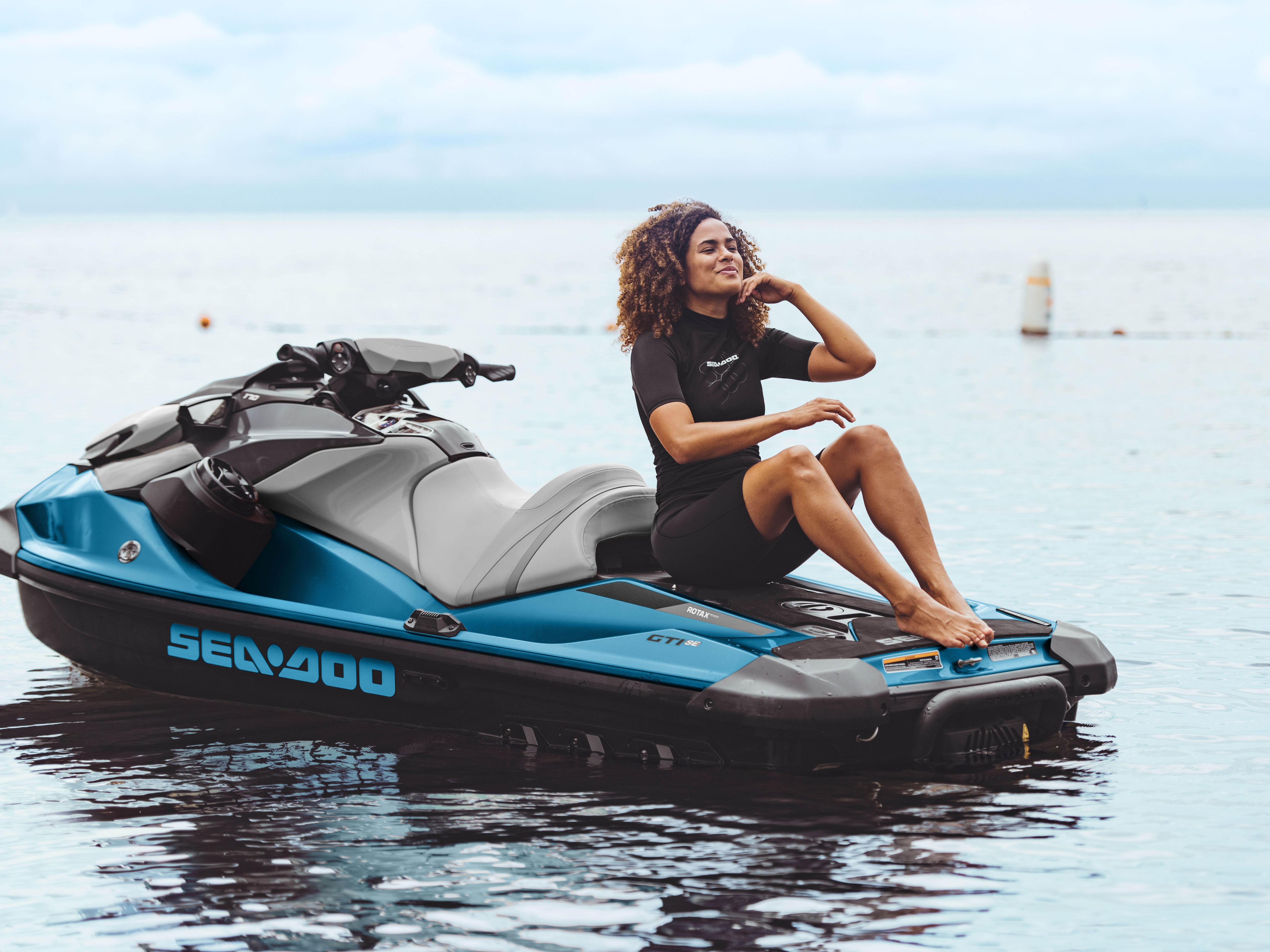 Woman siting on the Sea-Doo GTI SE large swim platform