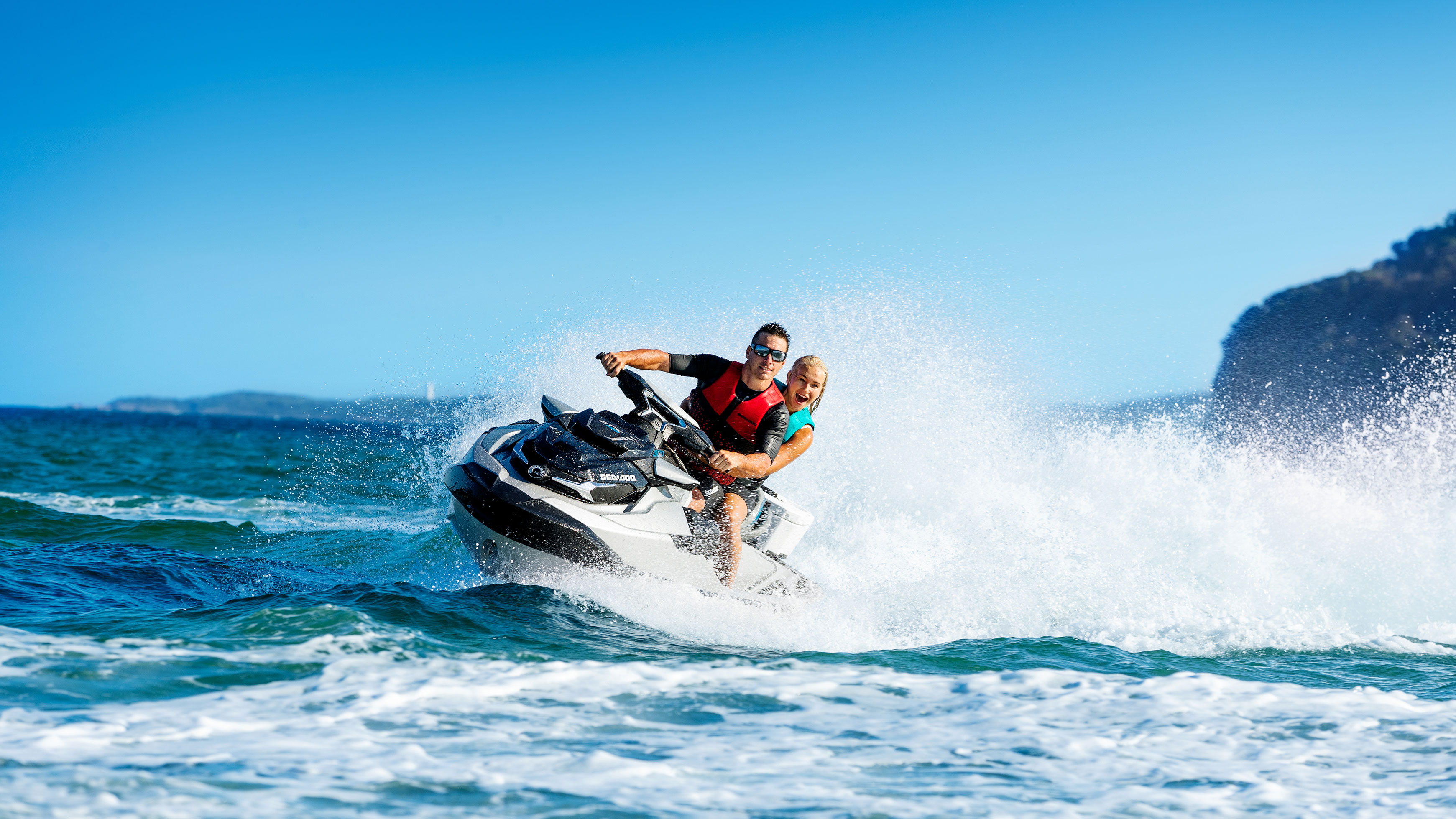 Couple riding on a Sea-Doo GTX Limited 