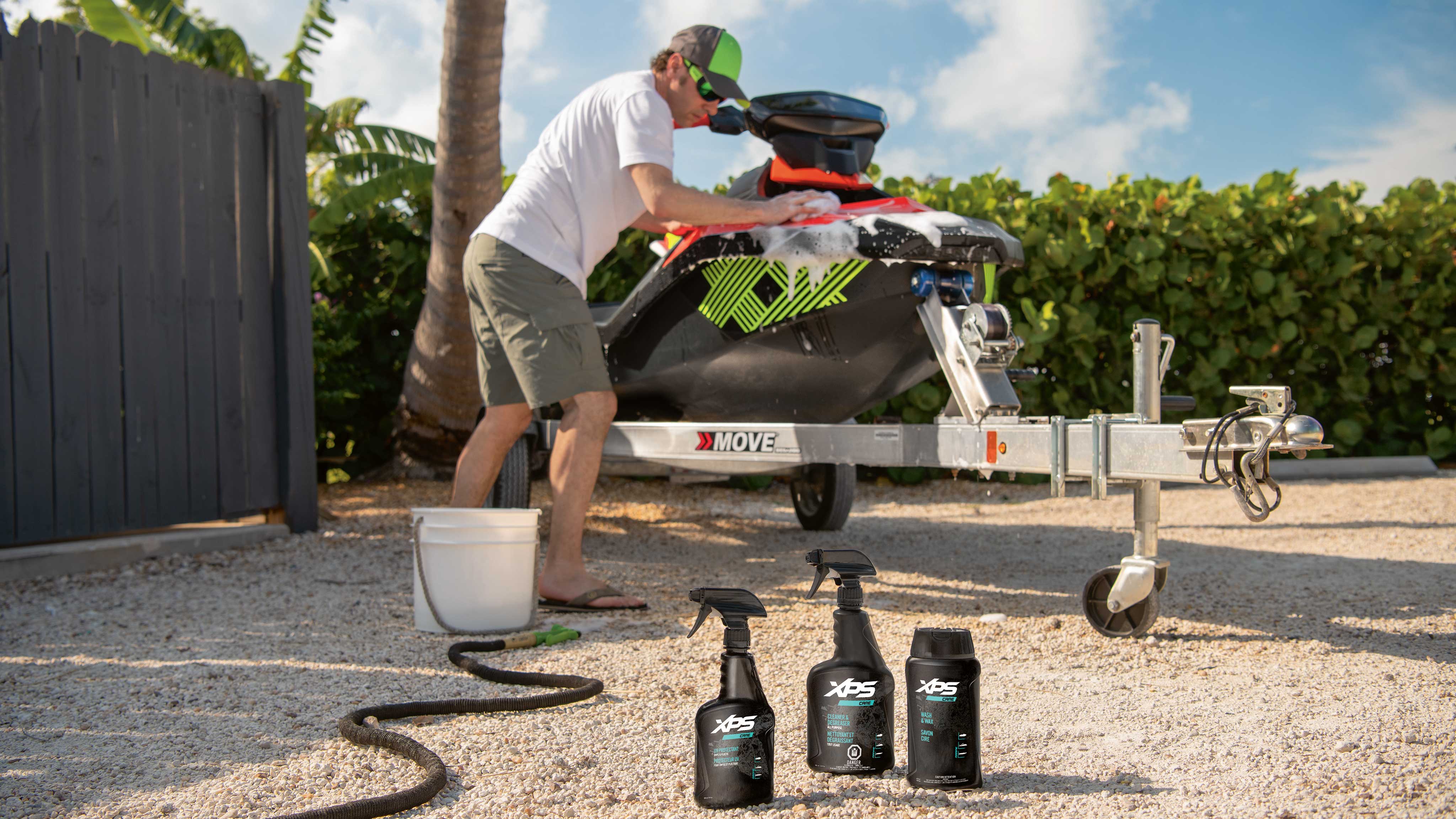 Men washing his Sea-Doo watercraft with XPS Care products
