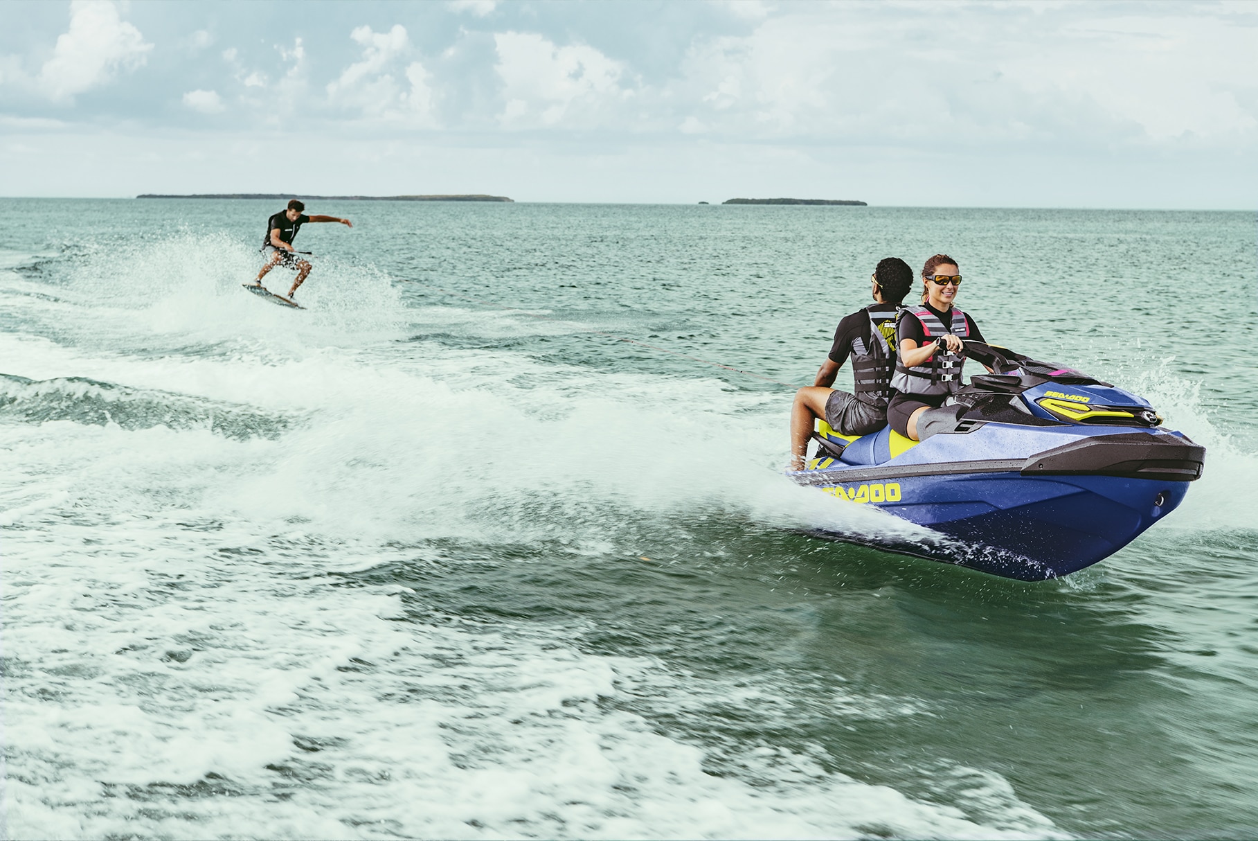 Couple towing a wakeboard with a Sea-Doo Wake