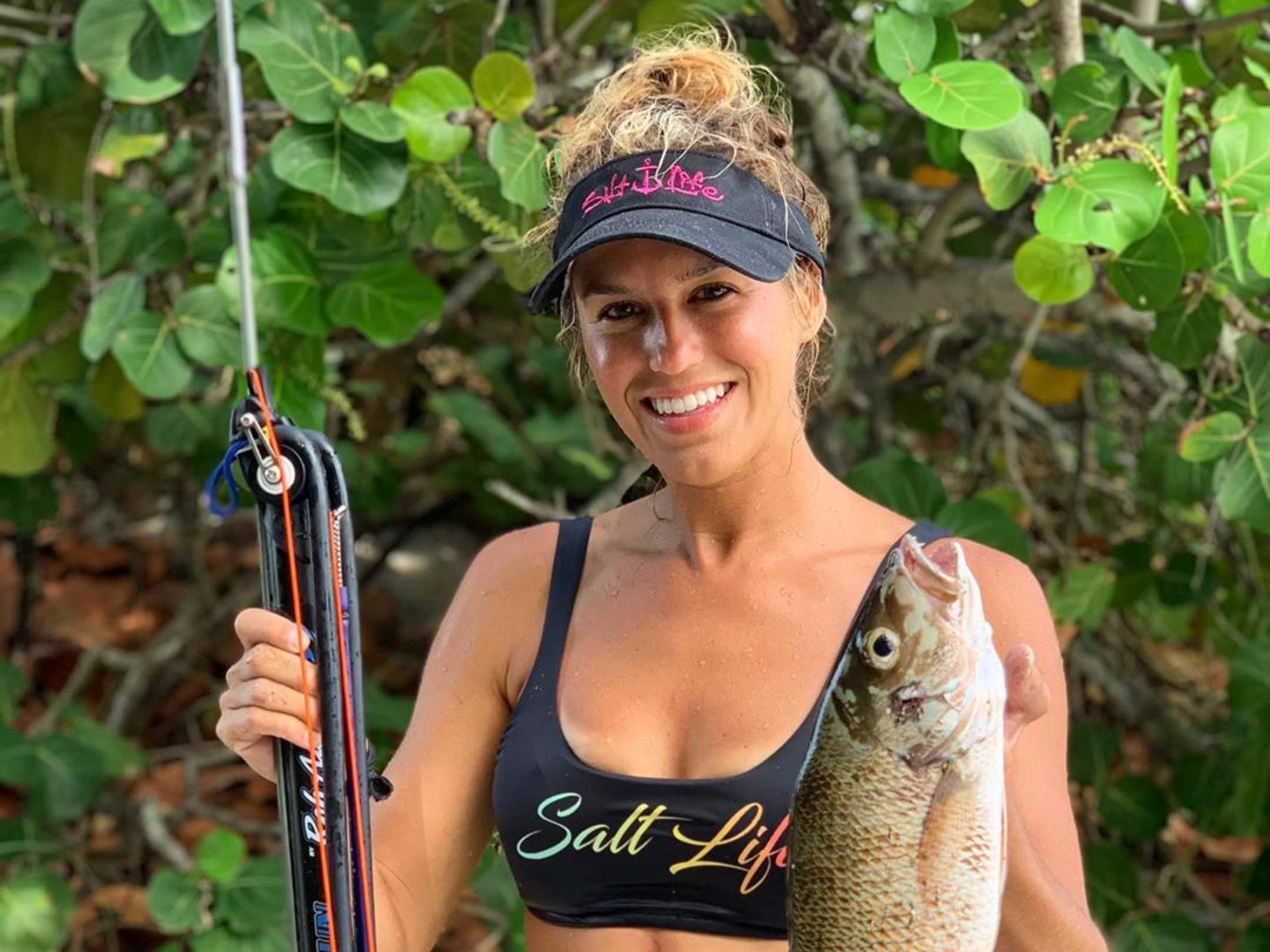 Bri Andrassy posing with a fish