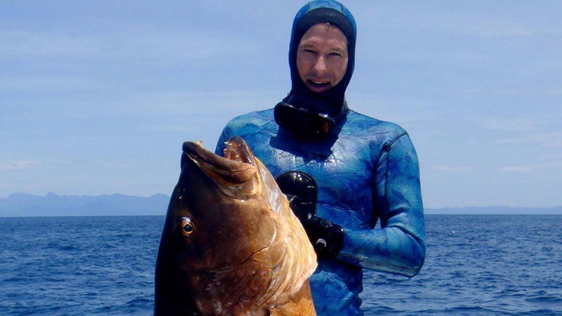 Cameron Kirkconnell posing with a big fish