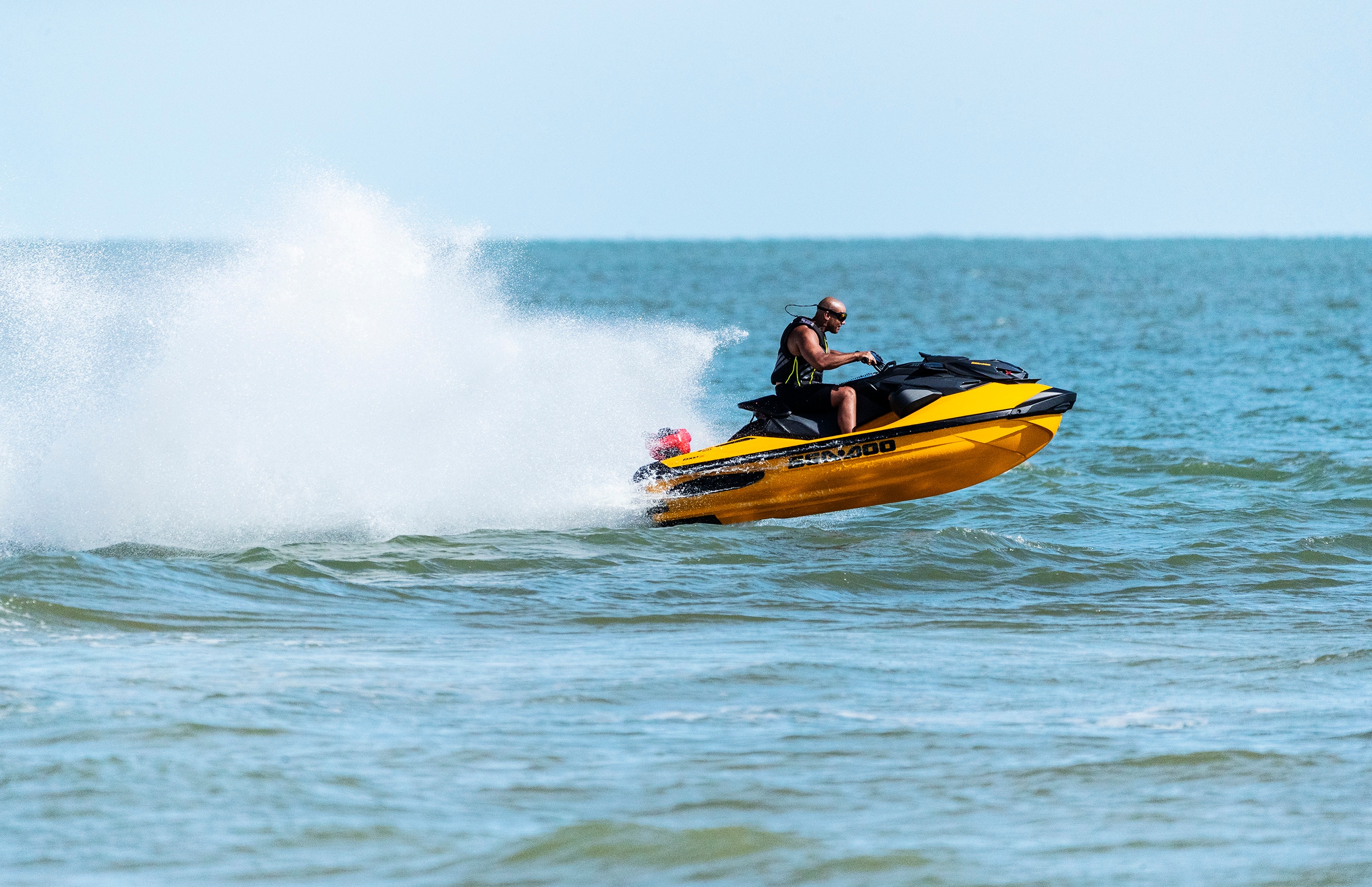 Man sipping a cup of tea on his Sea-doo personal watercraft