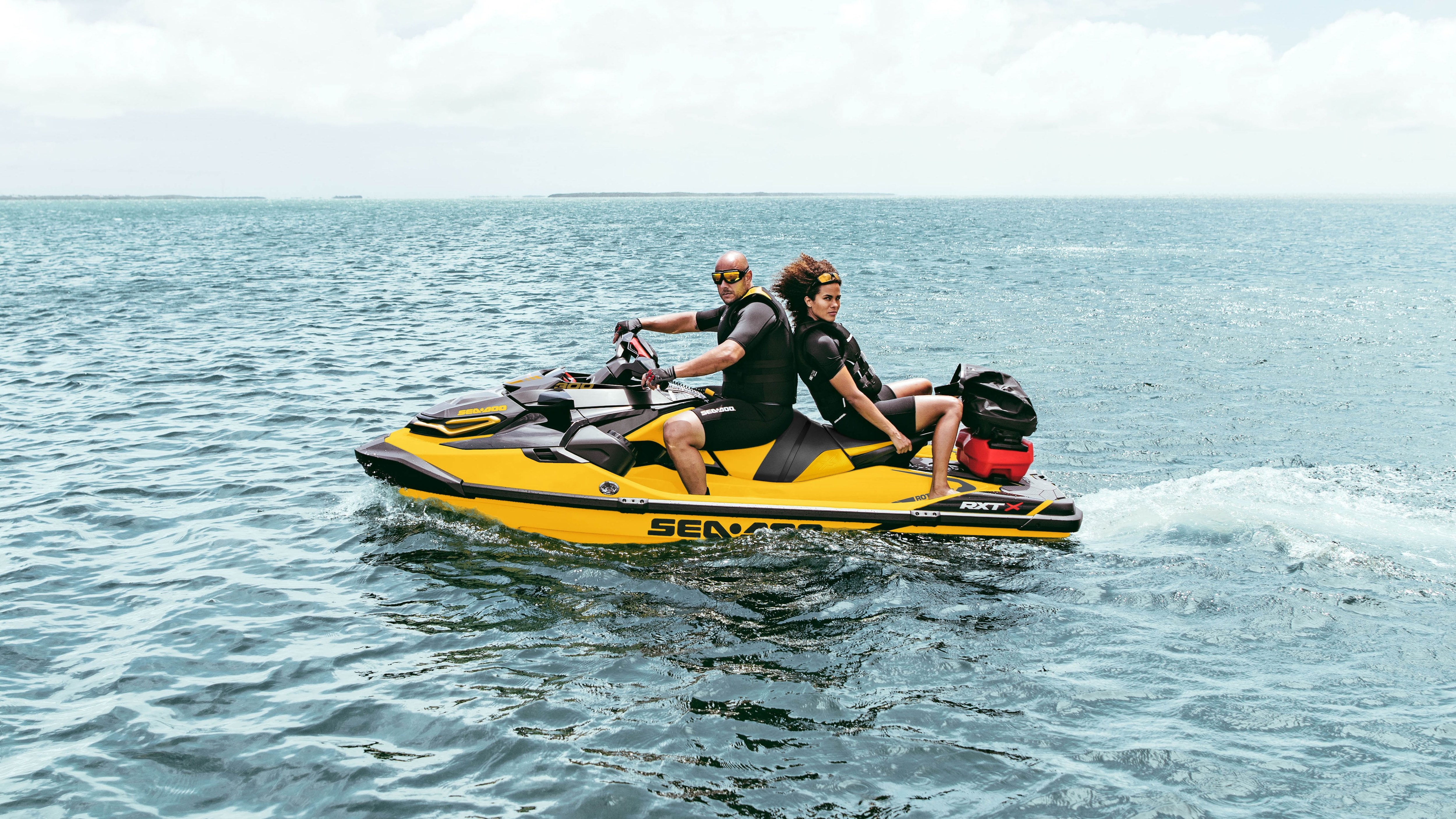 Couple riding a Sea-Doo RXT-X with the Cargo LinQ system