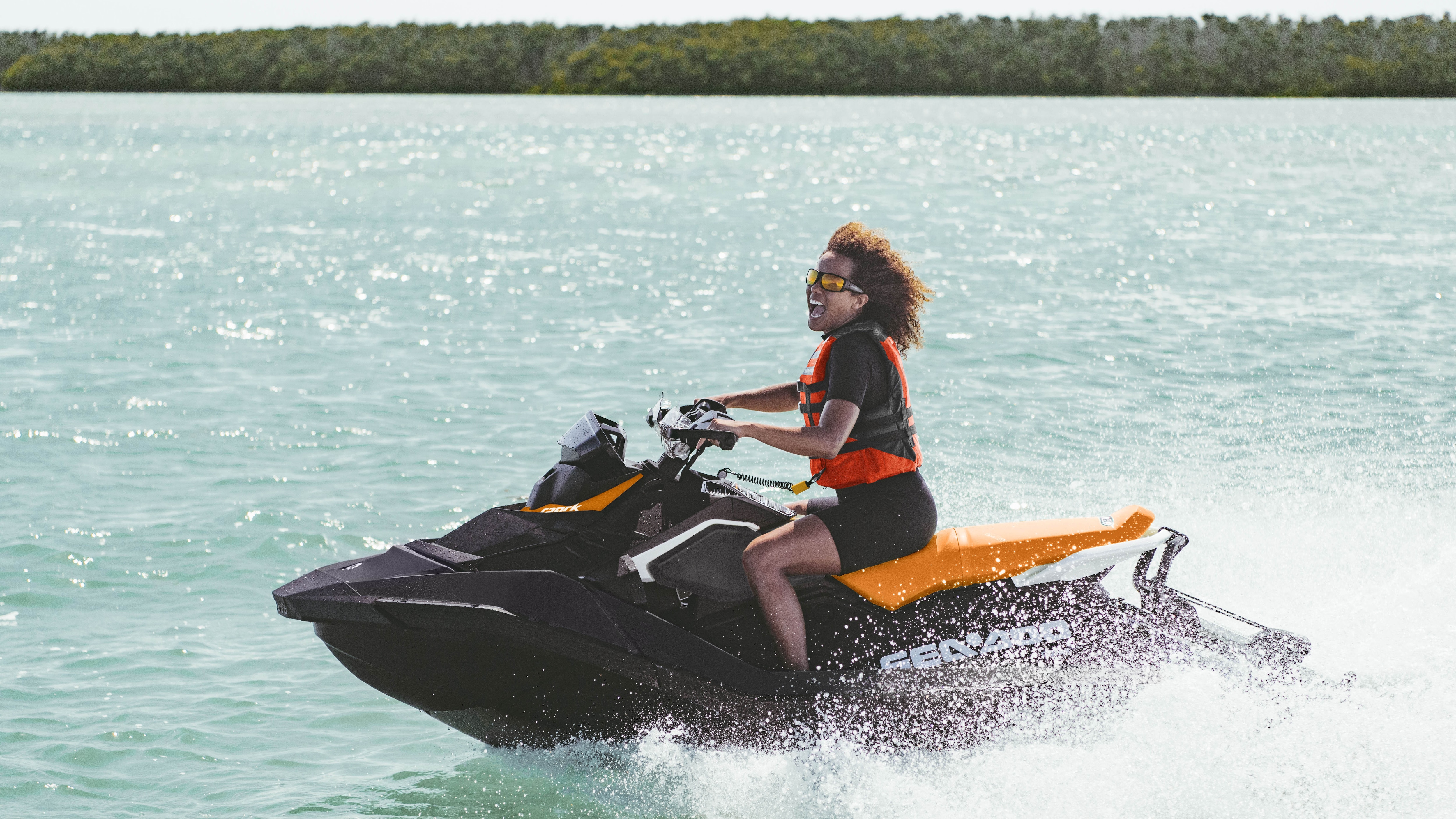 Nő élvezettel vezet egy Sea-Doo Spark jetskit