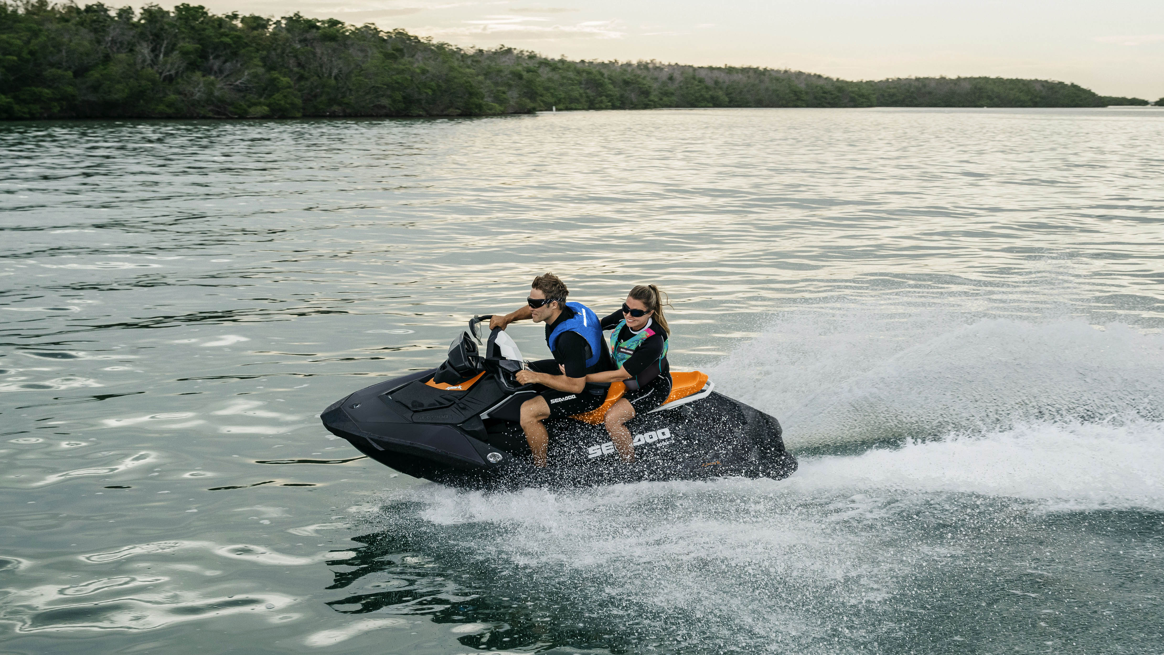 A couple riding their Sea-Doo Spark in the water