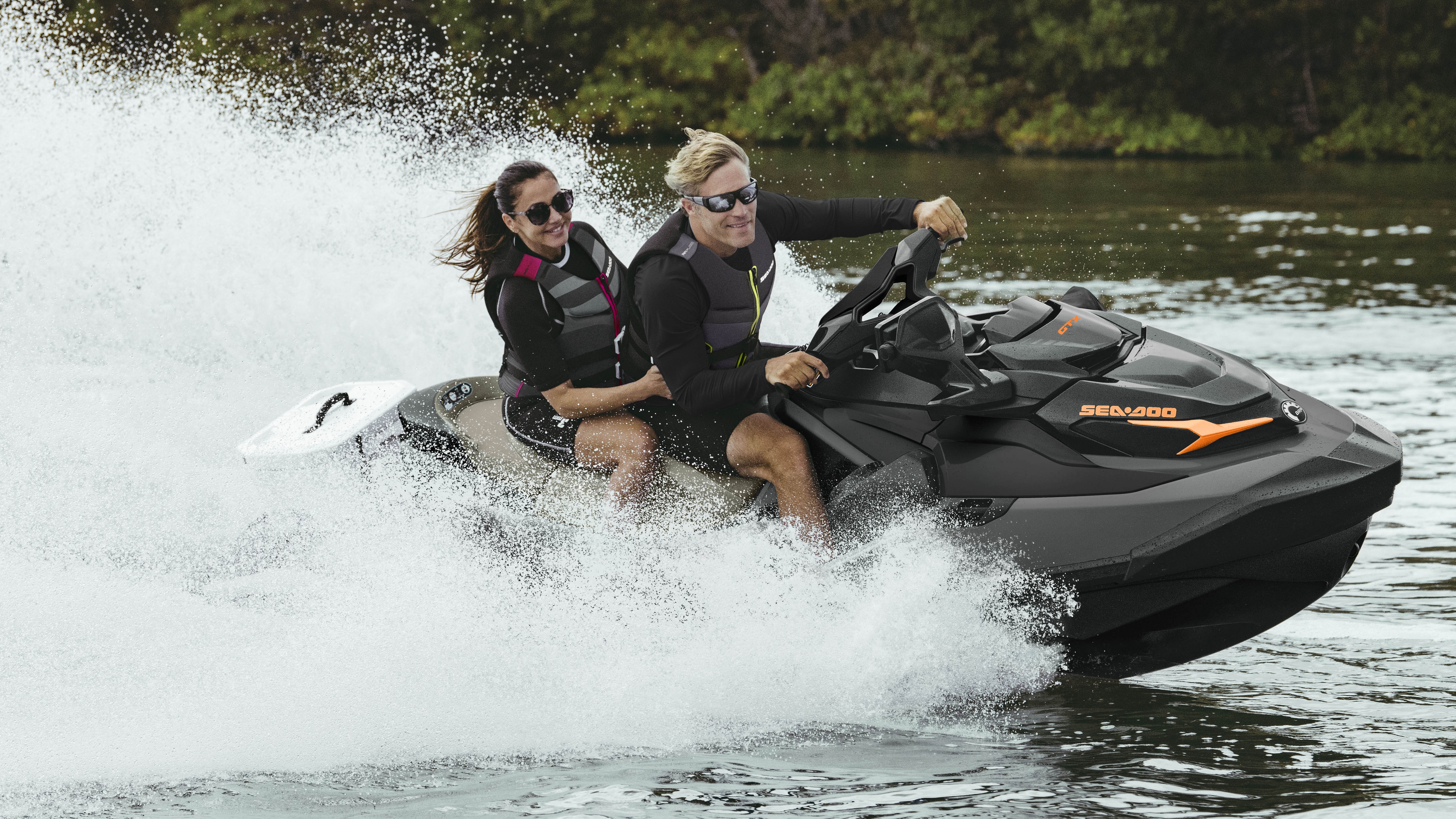 Couple riding a Sea-Doo GTX with the Cargo LinQ system