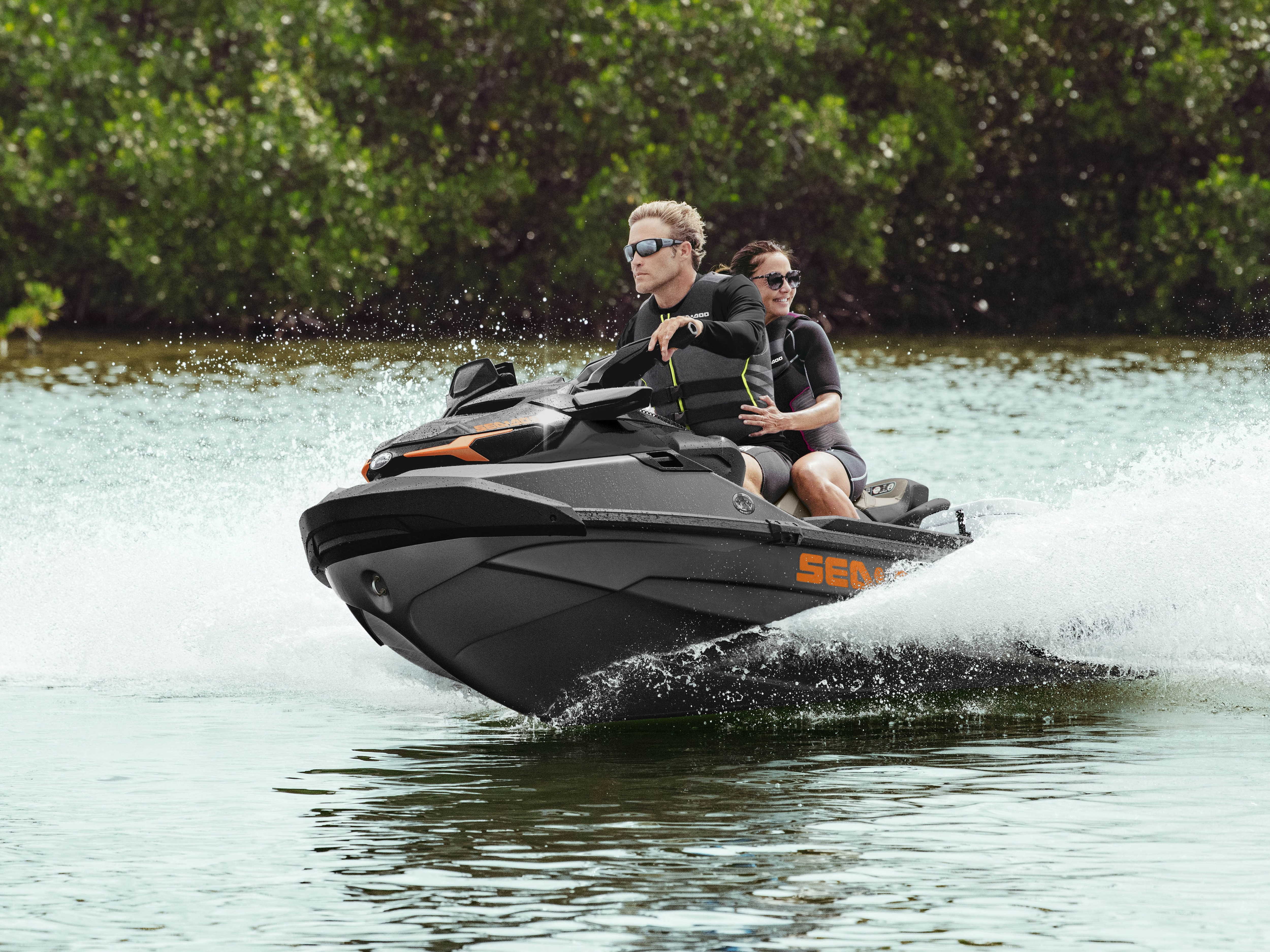 Couple riding a Sea-Doo GTX