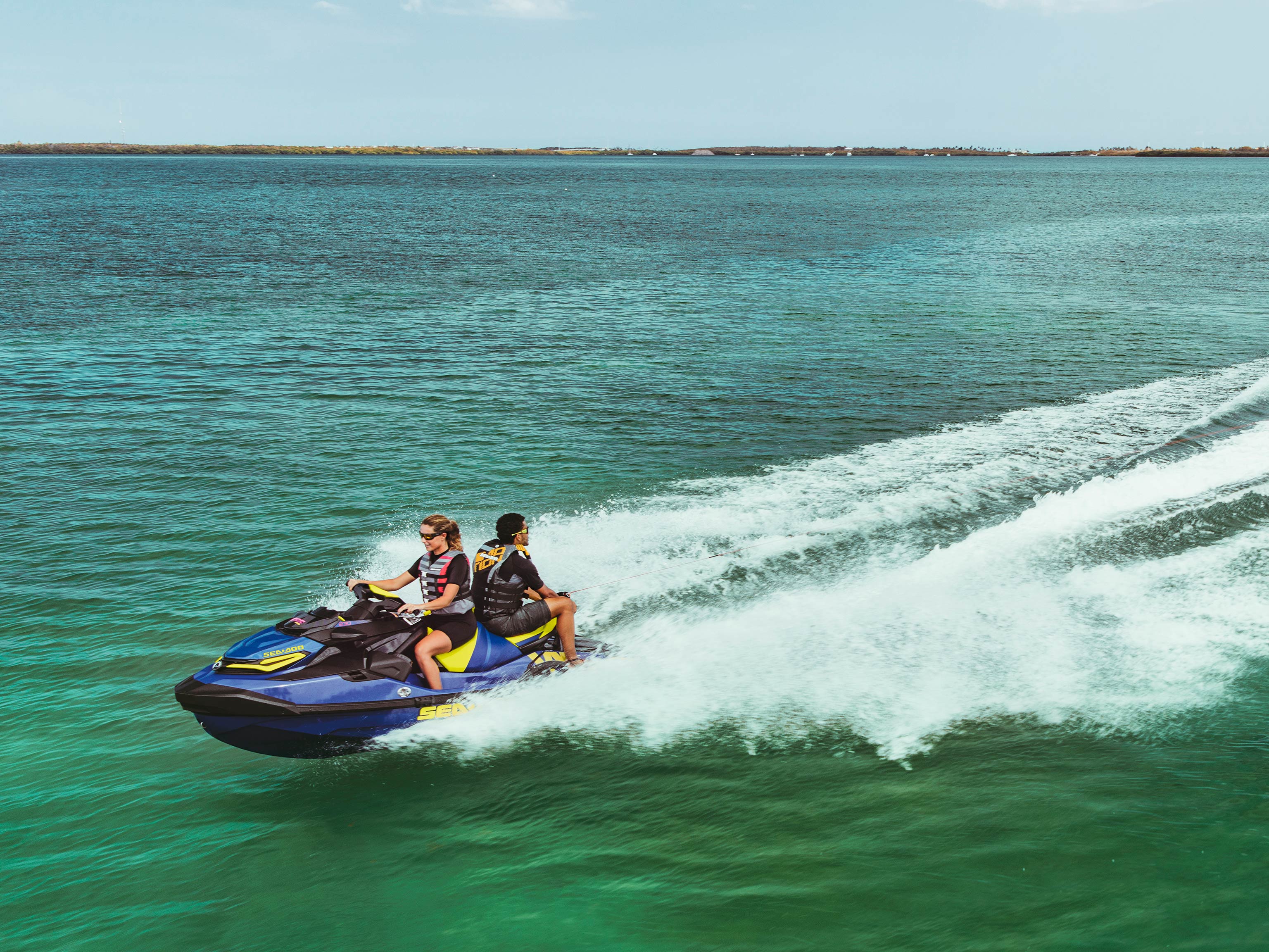 Couple riding a Sea-Doo Wake Pro with a ROTAX 1630 ACE - 230 HP ENGINE