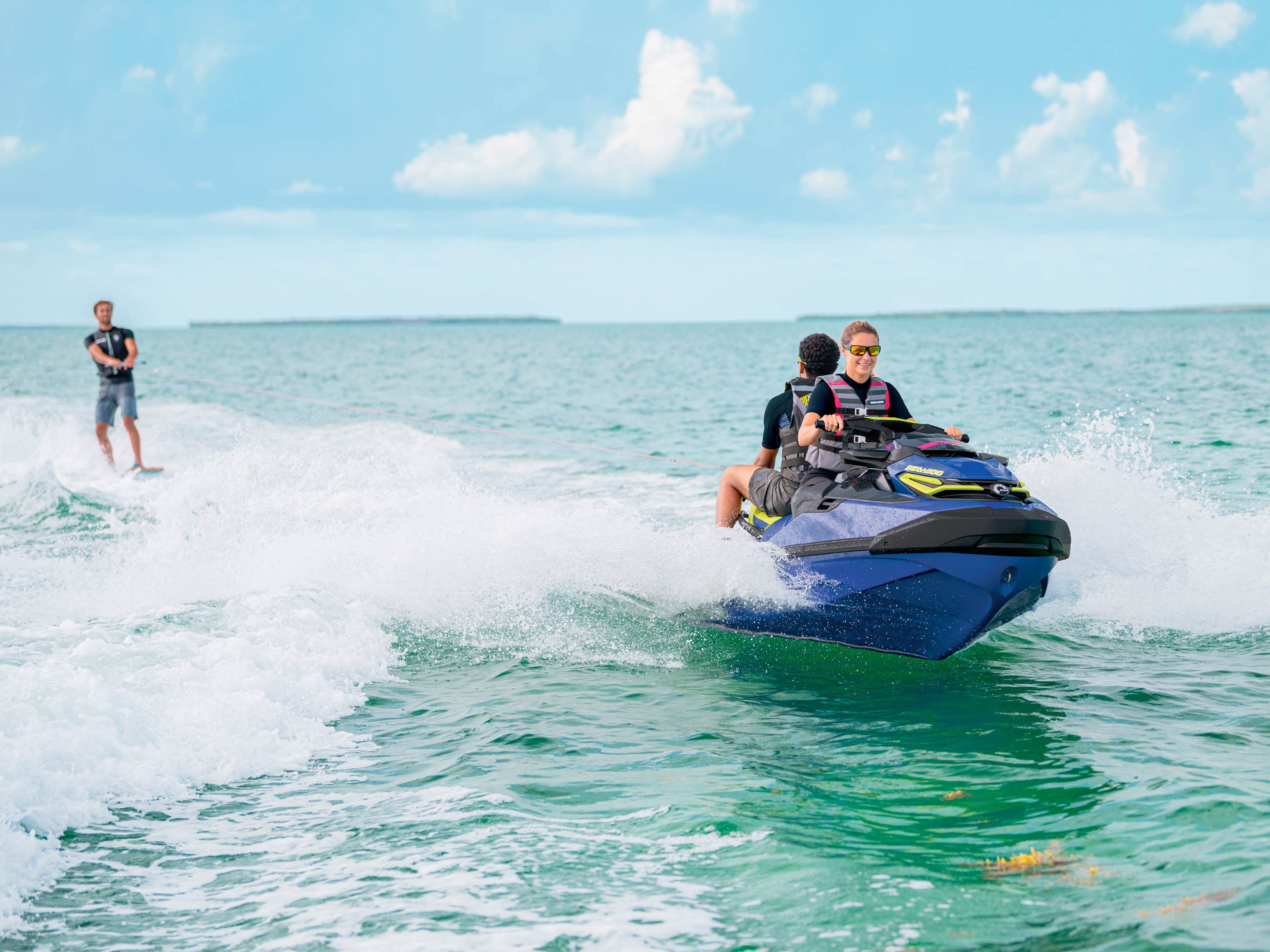 Group of three riding a Sea-Doo Wake Pro 230