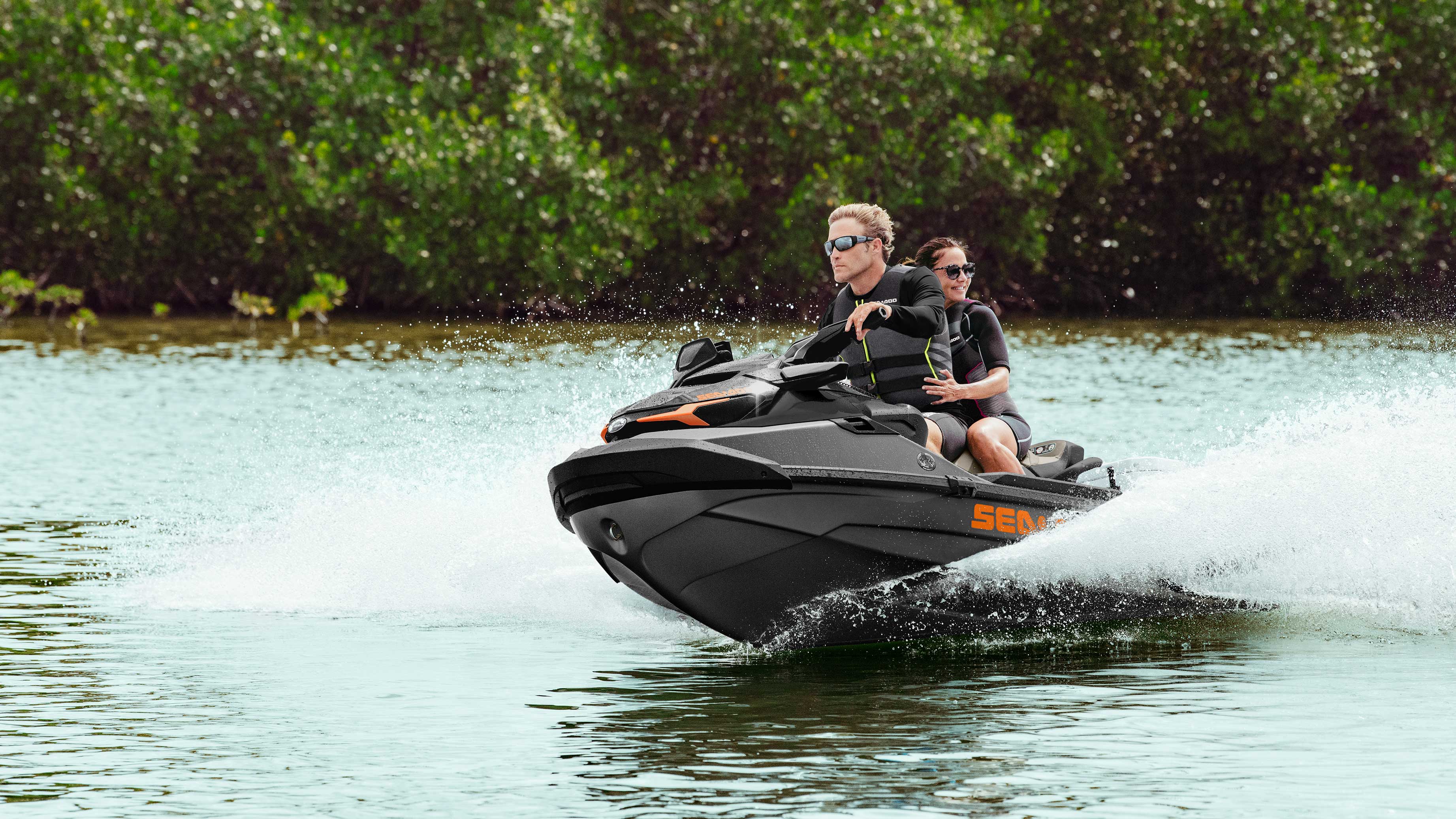 Couple riding a Sea-Doo GTX