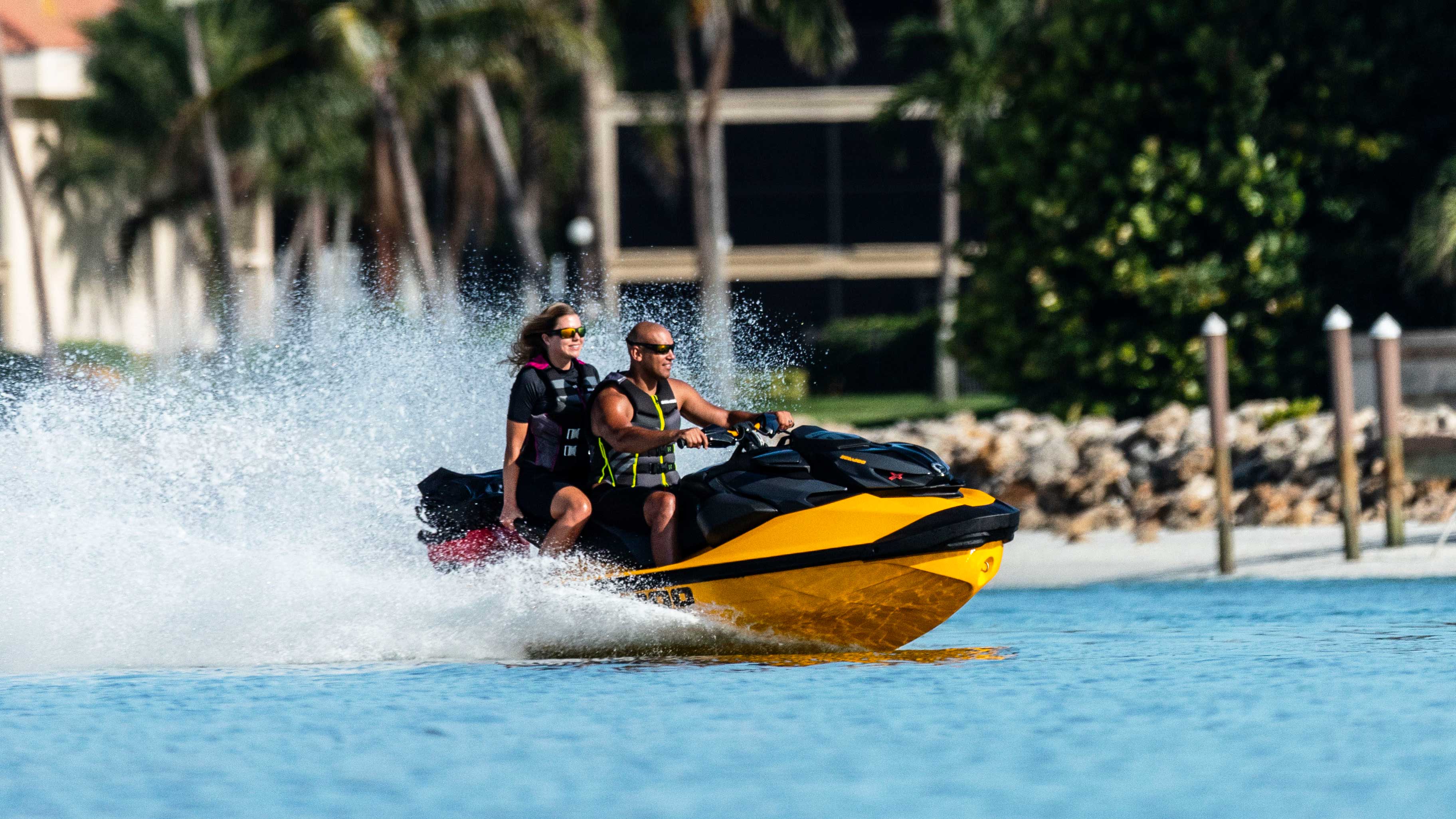 Couple on riding their yellow Sea-Doo RXP X