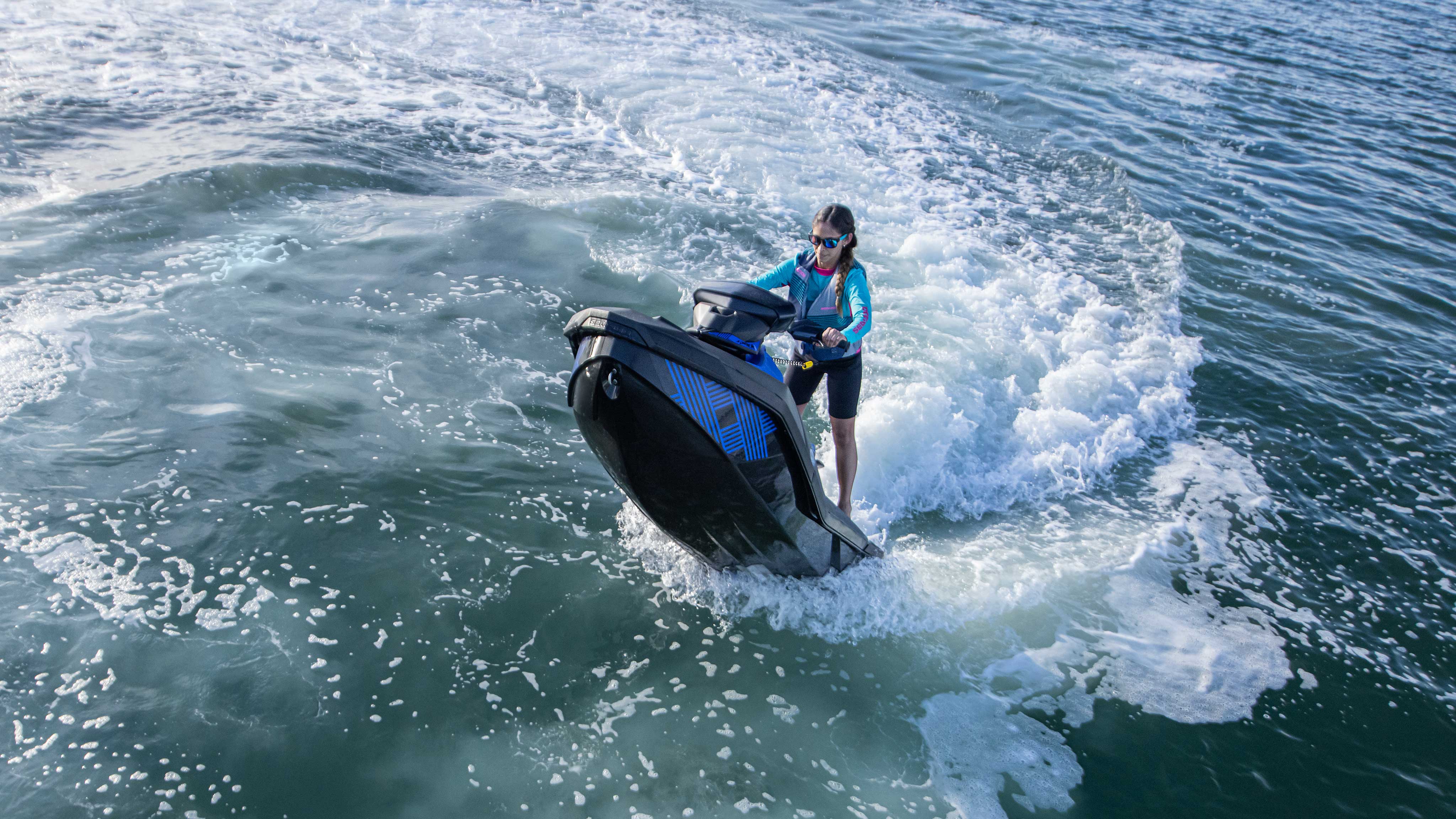 Woman doing a candle on her blue Sea-Doo Spark Trixx