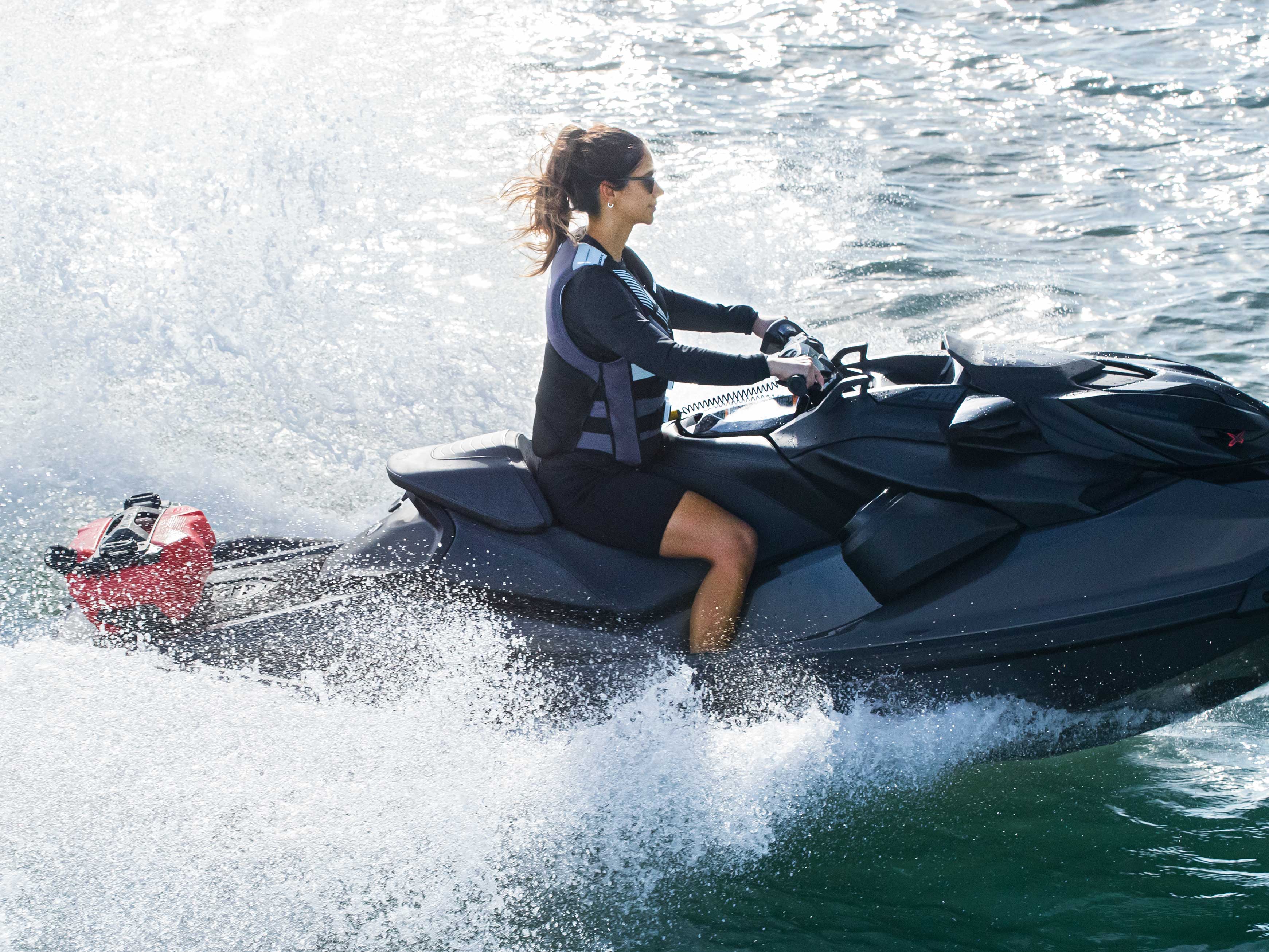 Woman riding a Sea-Doo RXP-X with a LinQ Fuel Caddy