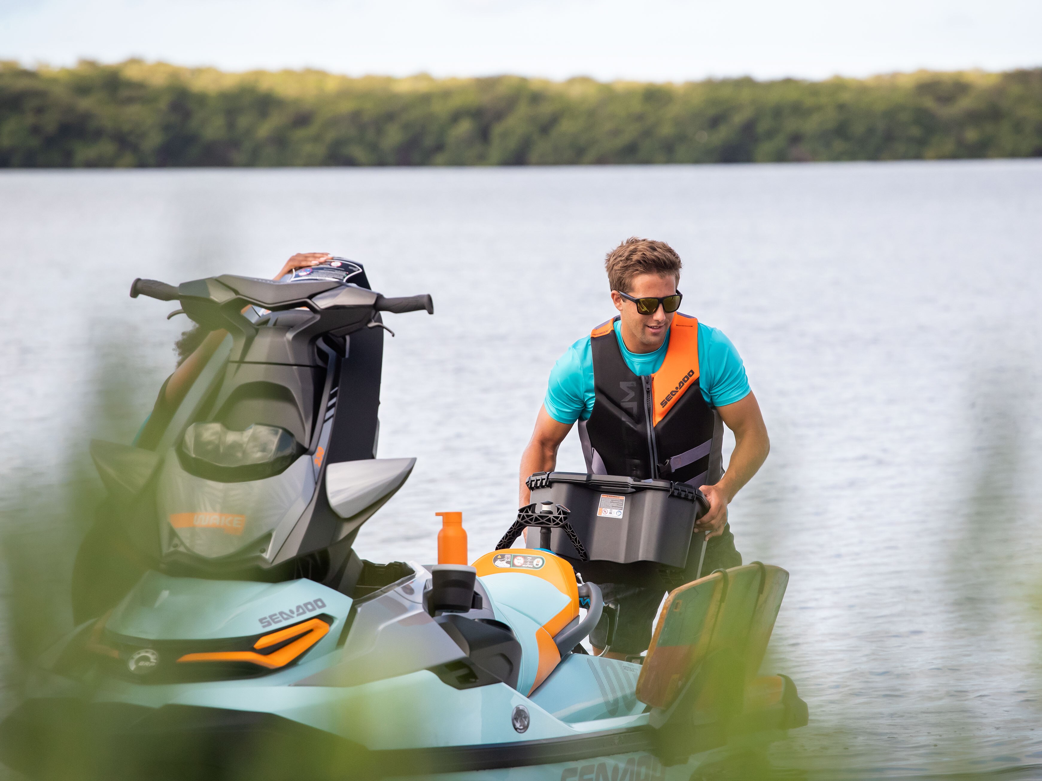 Man removing his Sea-Doo LinQ cooler from his Wake Pro Sea-Doo