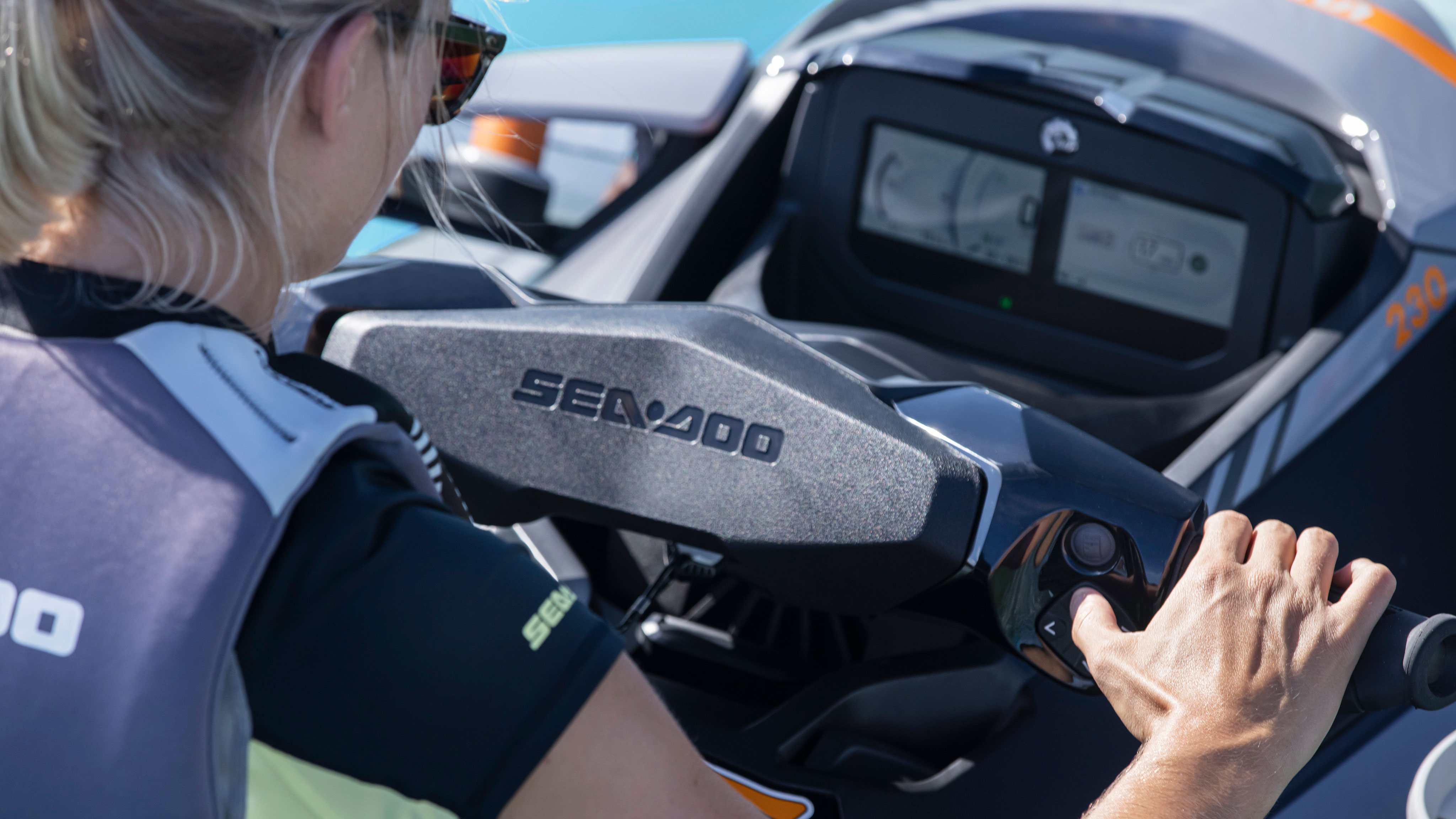 Woman using the LCD display with the Sea-Doo Handlebar control