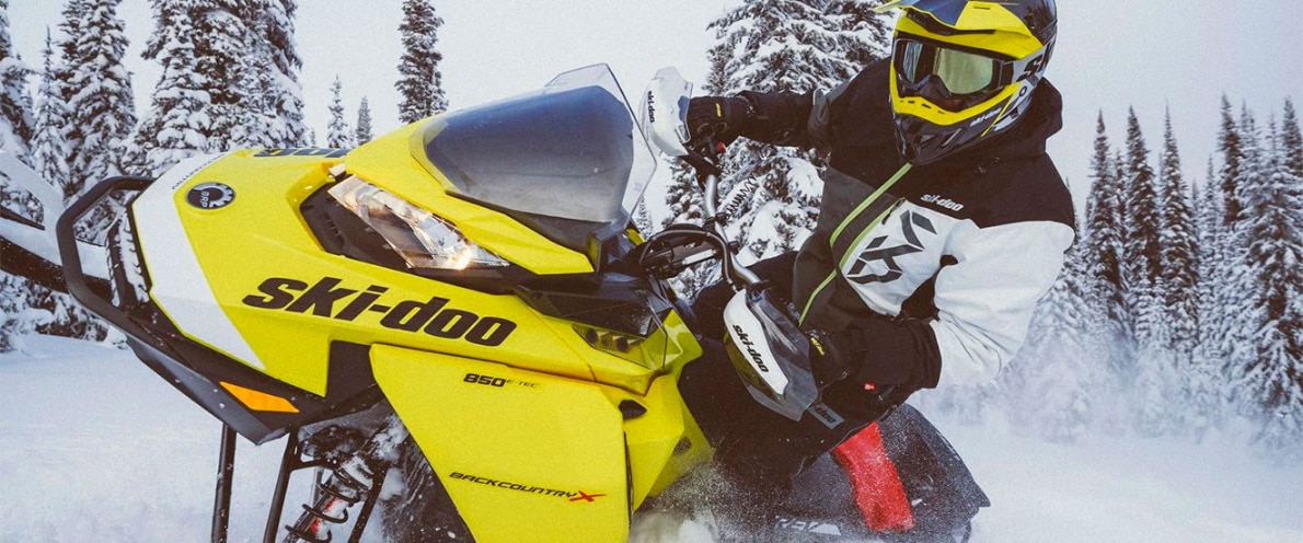 Man doing a wheelie on his Renegade snowmobile