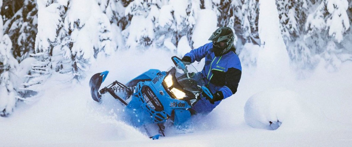 Man drifting through snow on his Renegade snowmobile