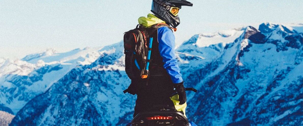 Man standing up on his Freeride snowmobile