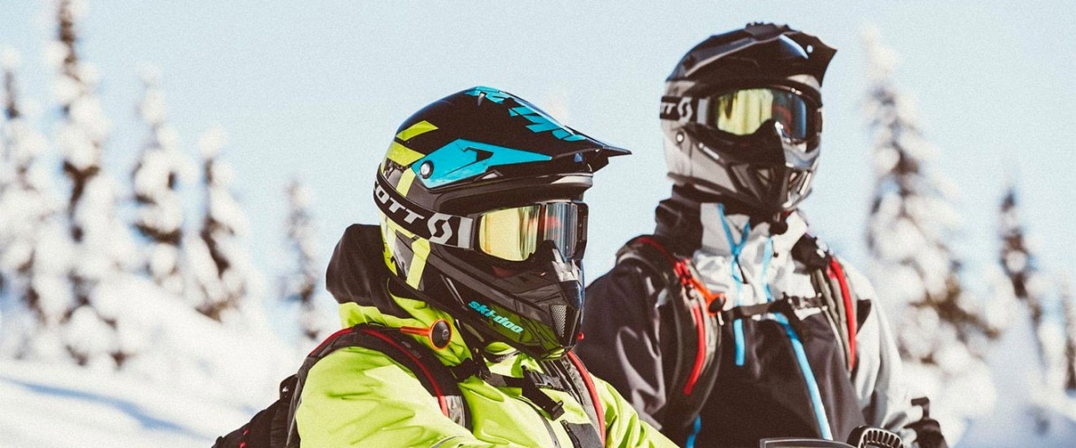 Close-up of two friends near a snowy forest