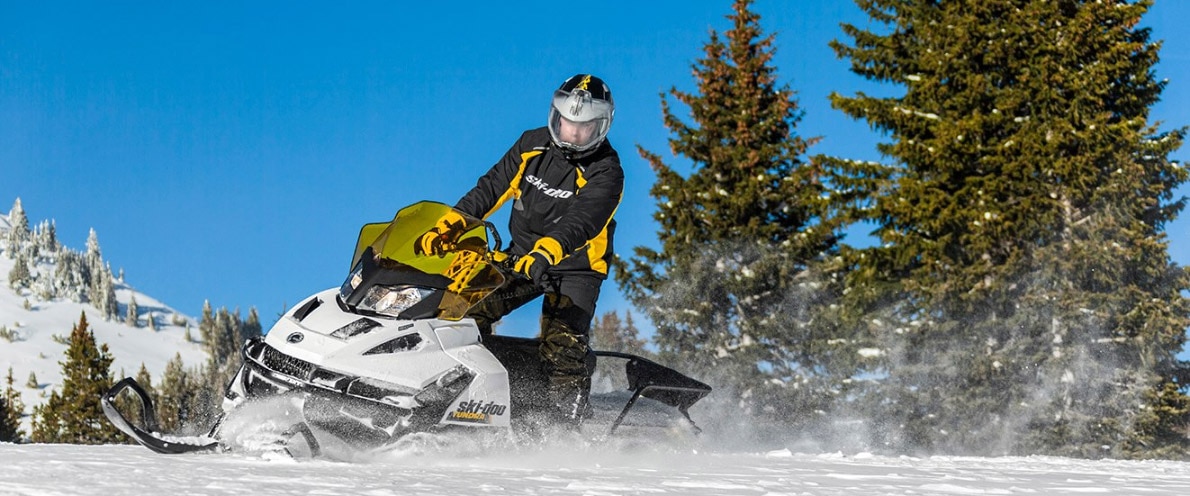 Man stepping down his Ski-Doo Tundra snowmobile