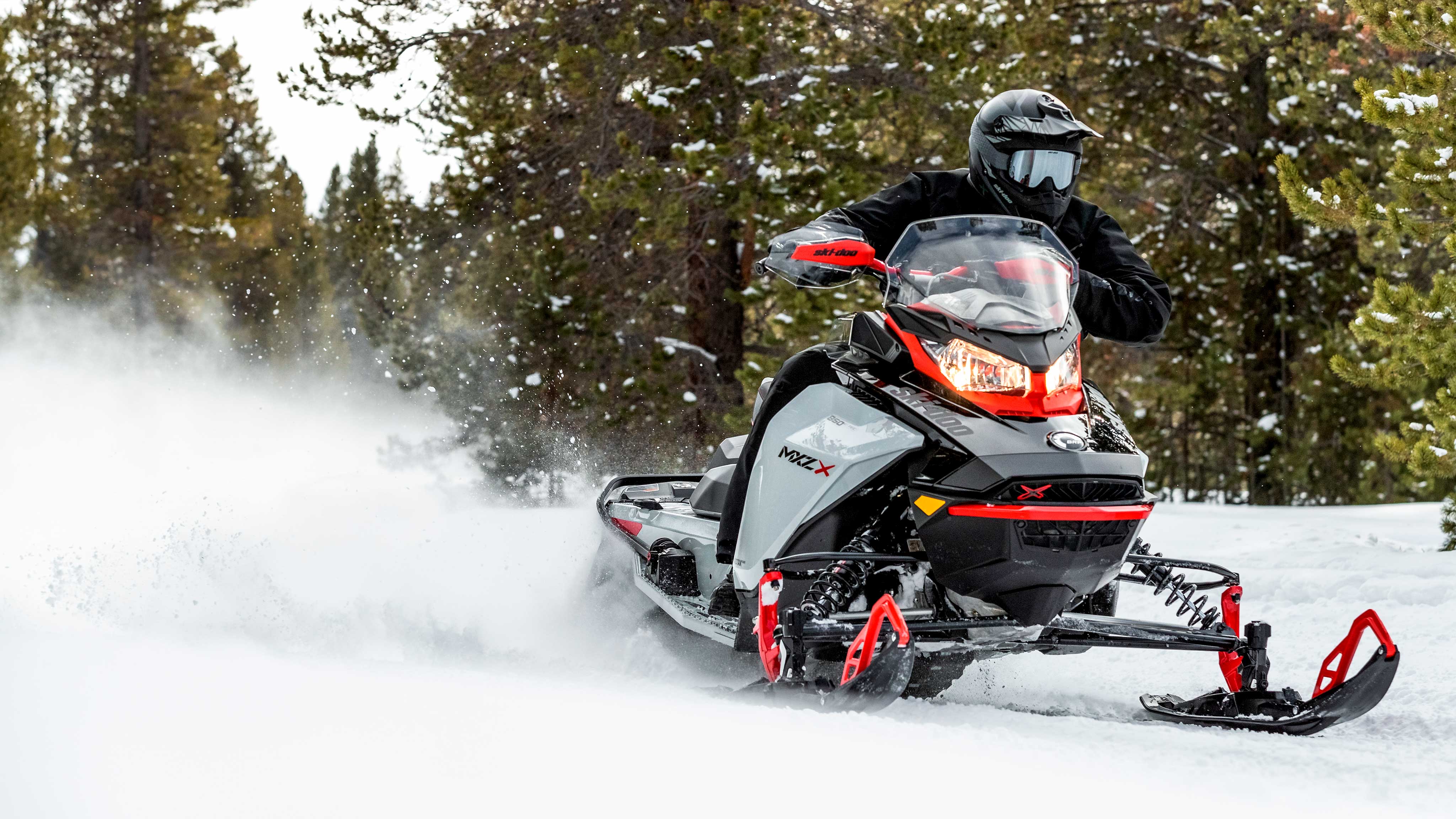 Man driving a Ski-Doo MXZ in a trail