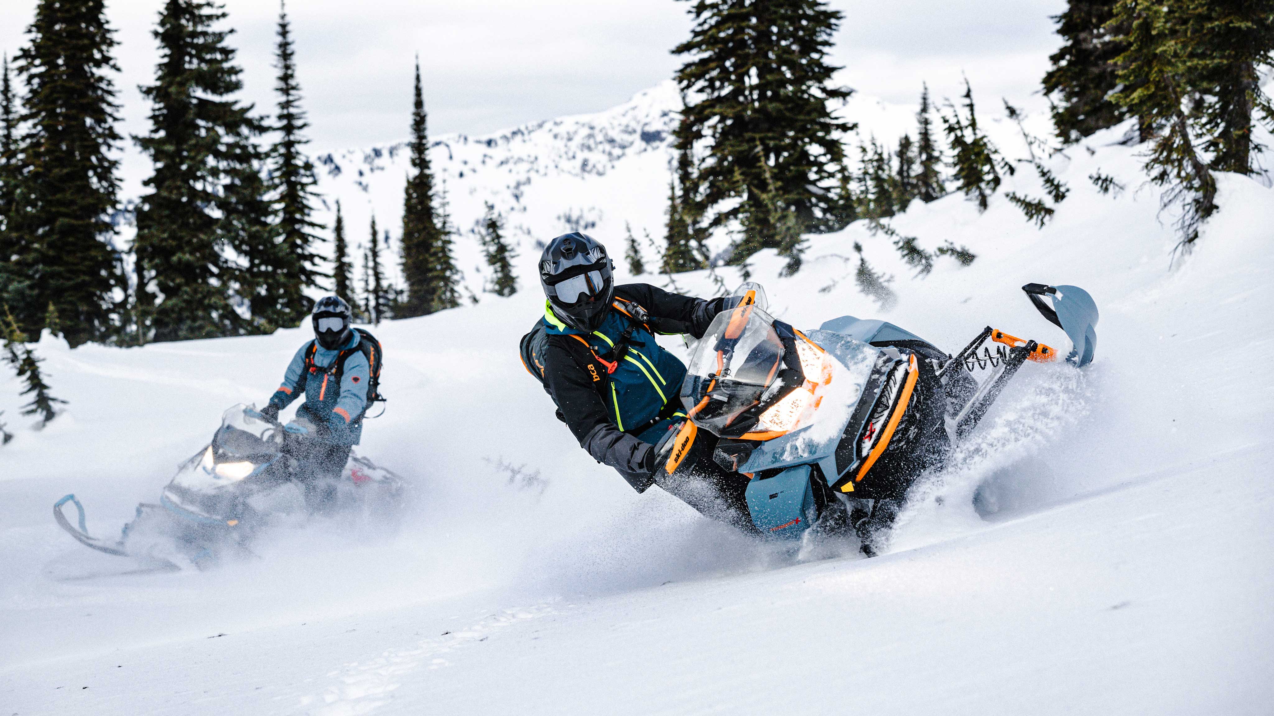 Men riding Ski-Doo snowmobiles