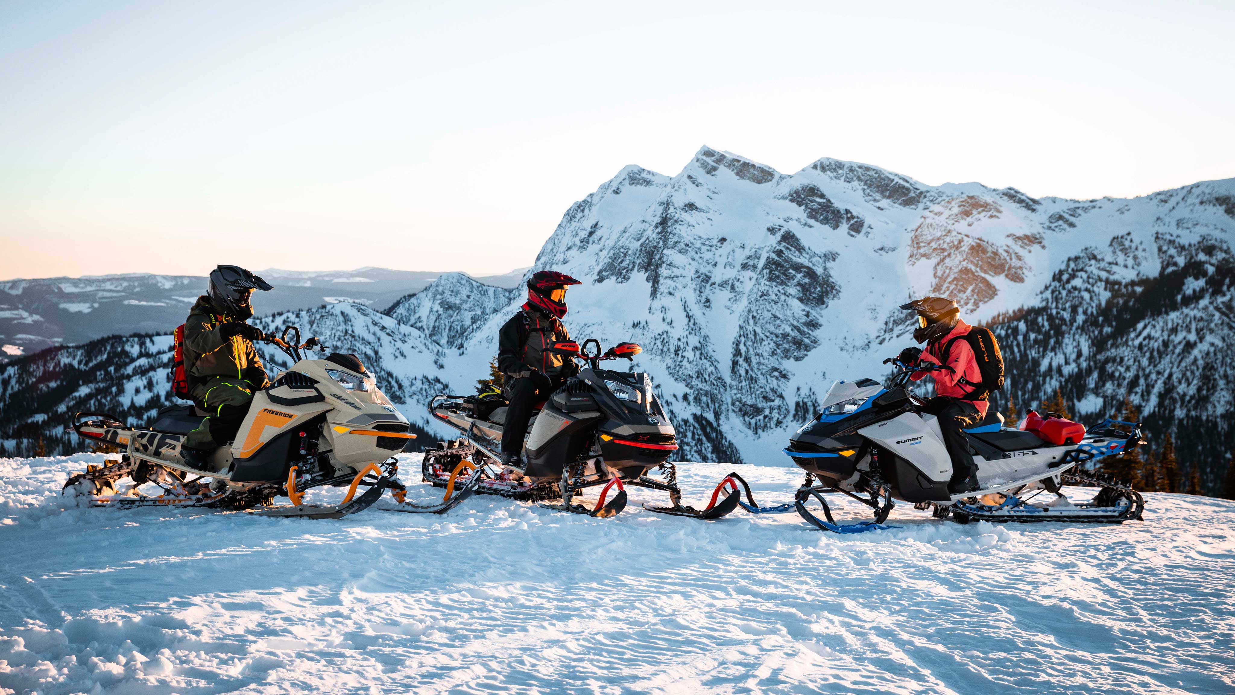 Family riding Ski-Doo snowmobiles