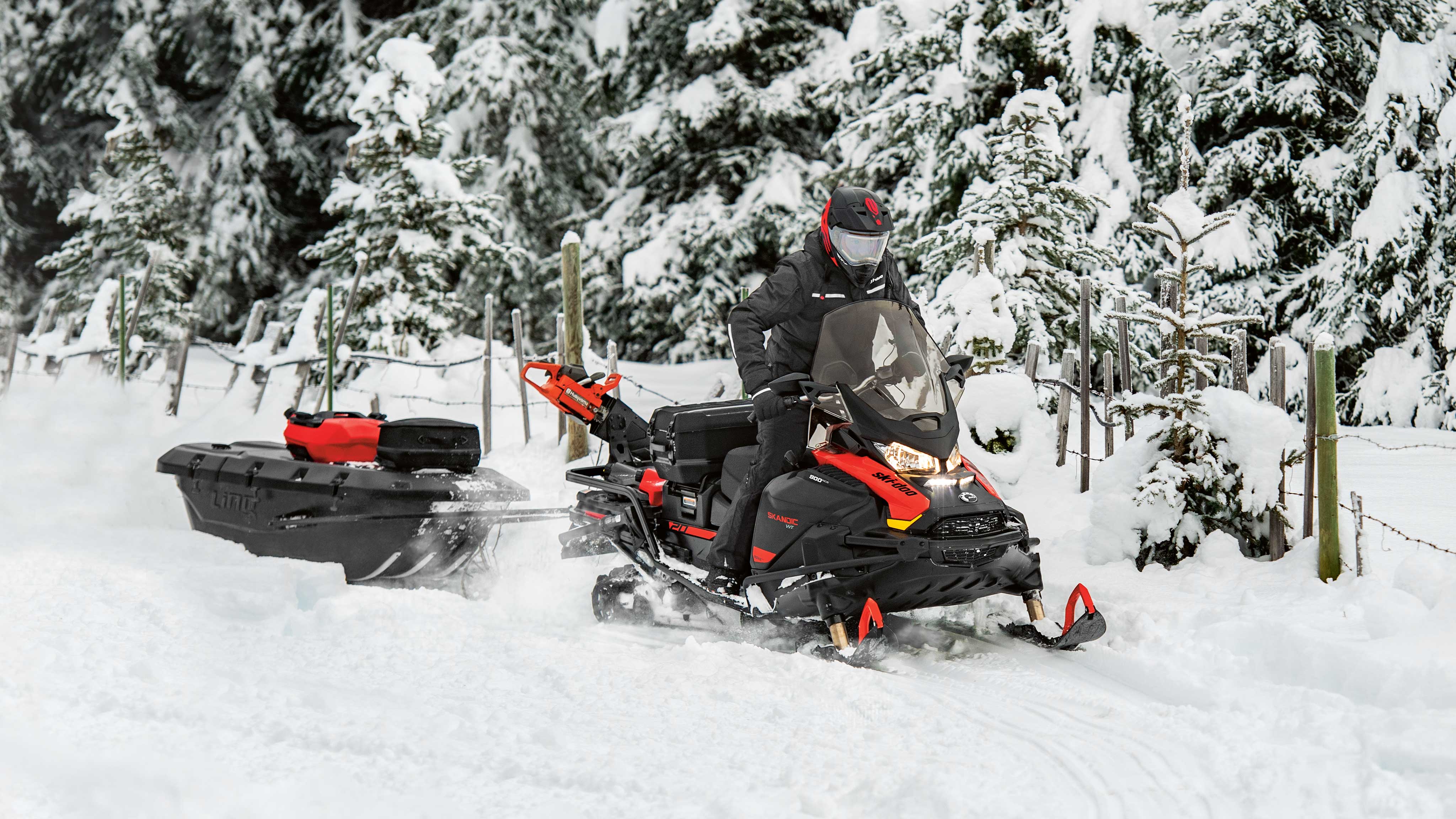 Man riding a Ski-Doo Skandic with a sled