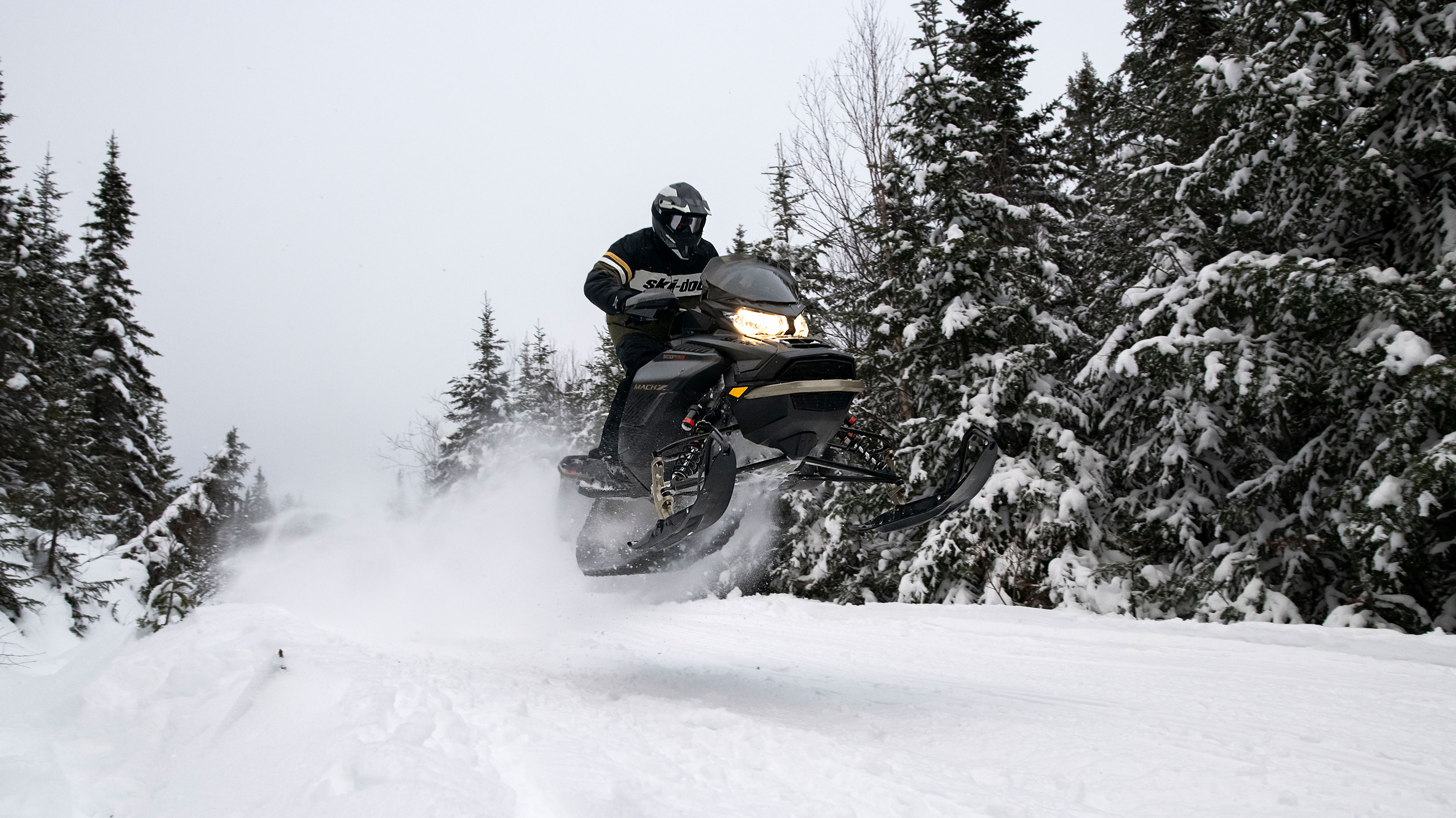 Man jumping with his Ski-Doo Mach-Z on a trail