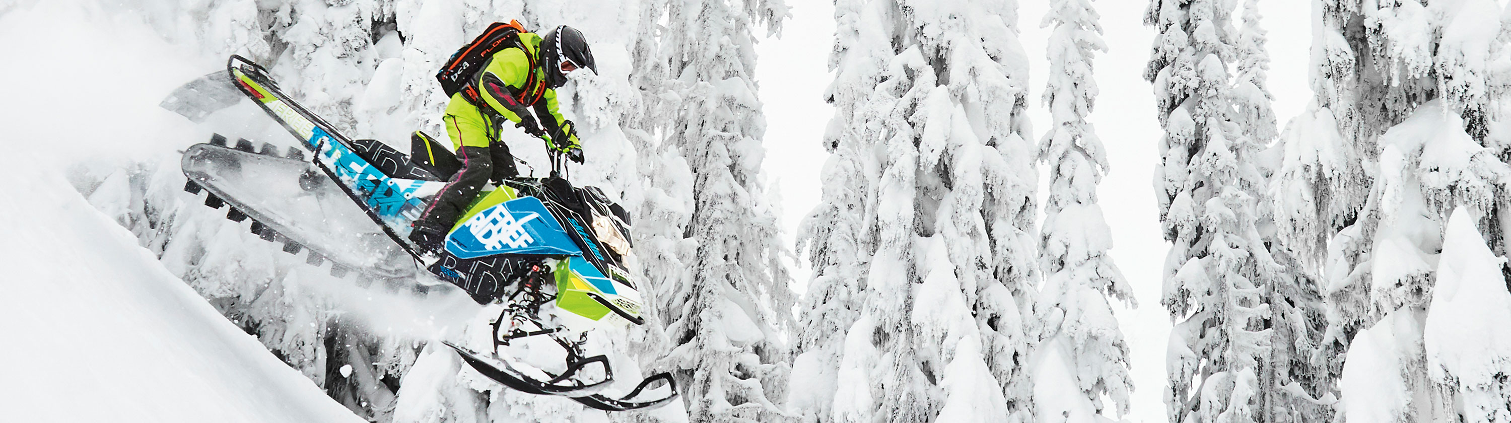 Man riding Ski-Doo Snowmobile with SCS Wrap