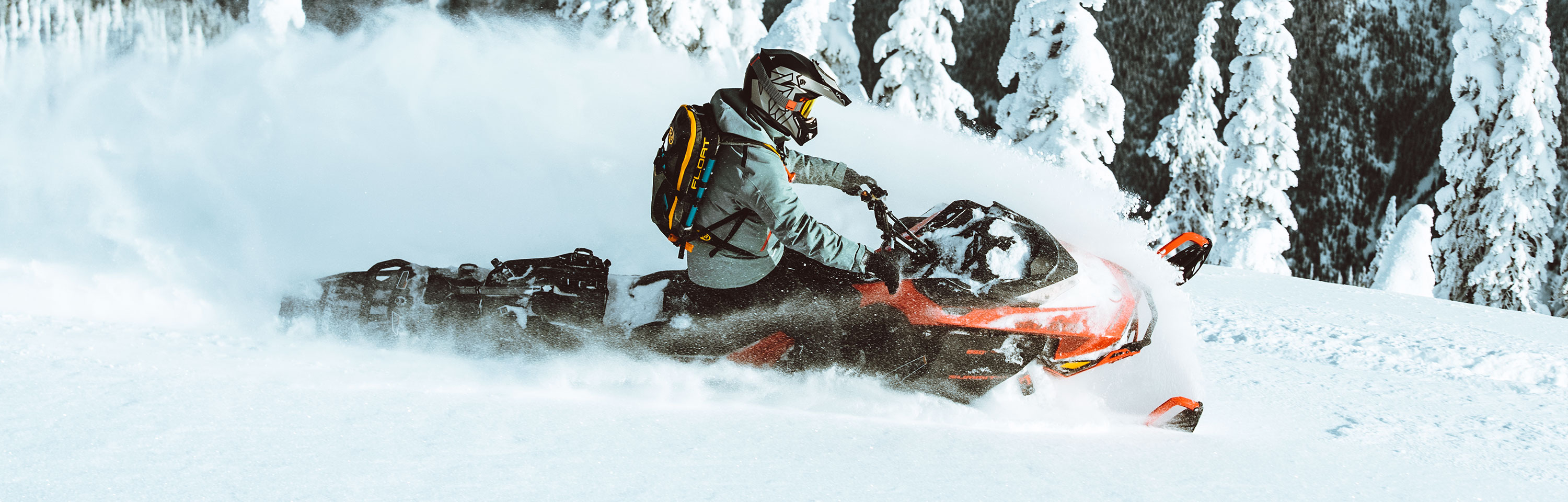 Man riding a snowmobile with High Tech Snowmobile Riding Gear