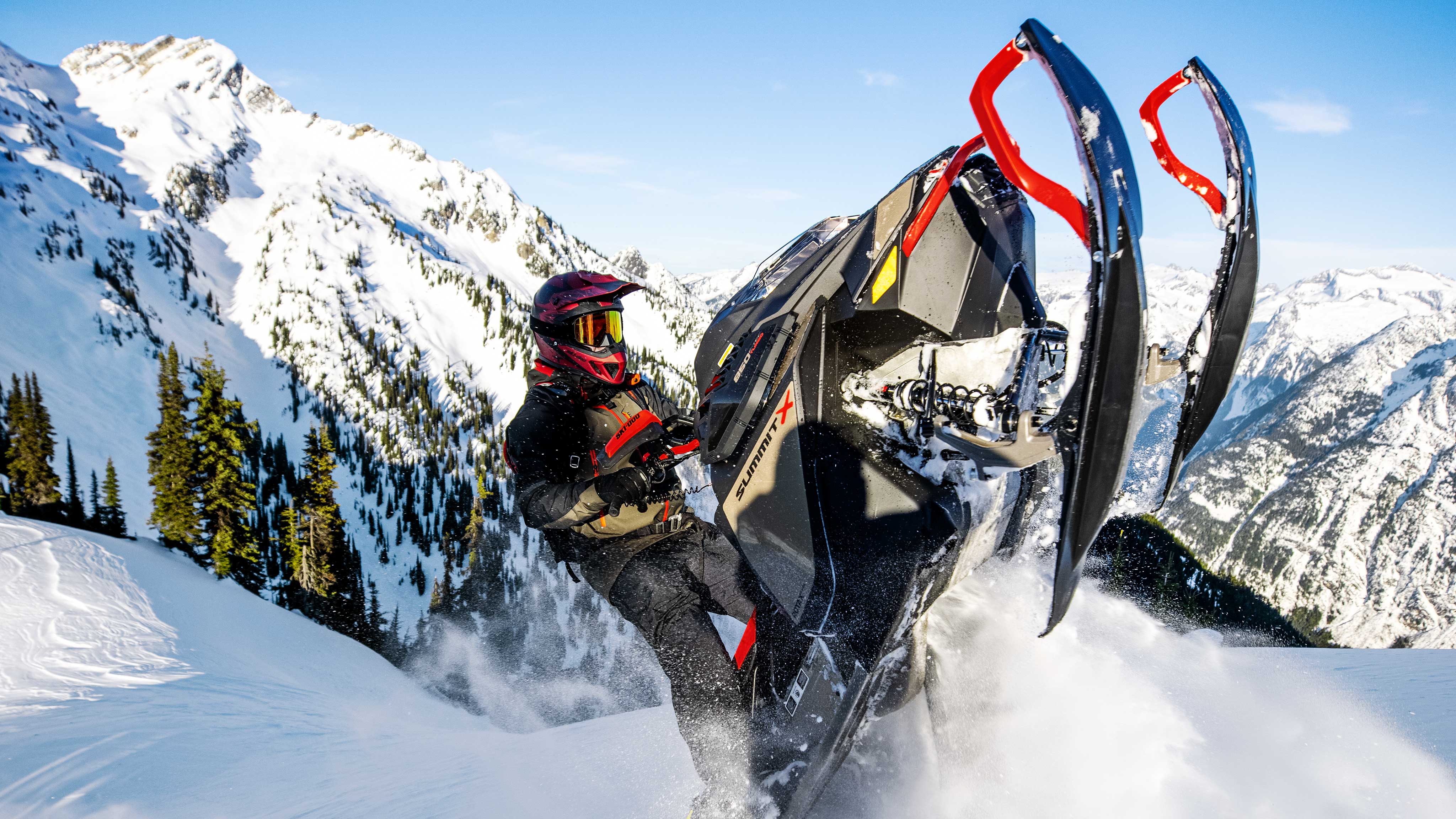 Men riding a Summit X with Expert package on top of a mountain