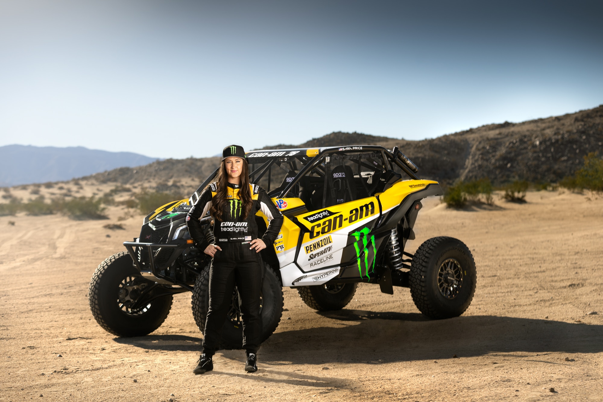 Sara Price standing infront of a side-by-side vehicle