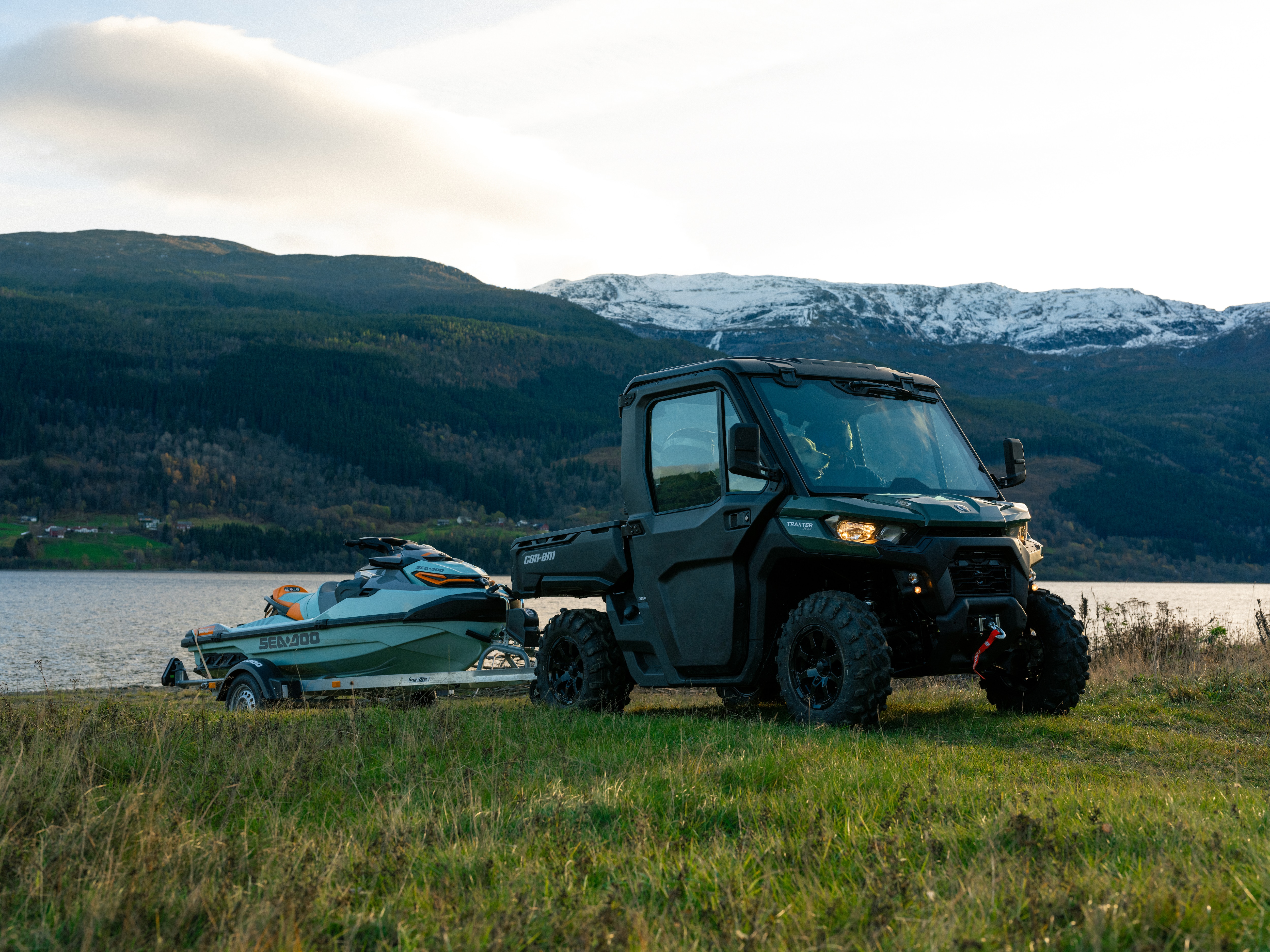 Can-Am TRAXTER towing a boat close to lake