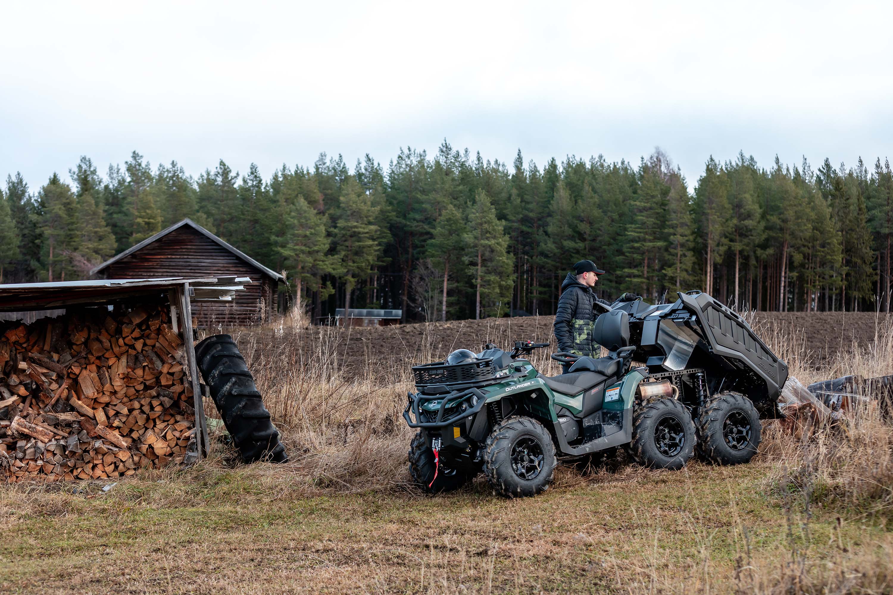 A welder working in front of their Desert Tan and Timeless Black Can-Am Defender Limited