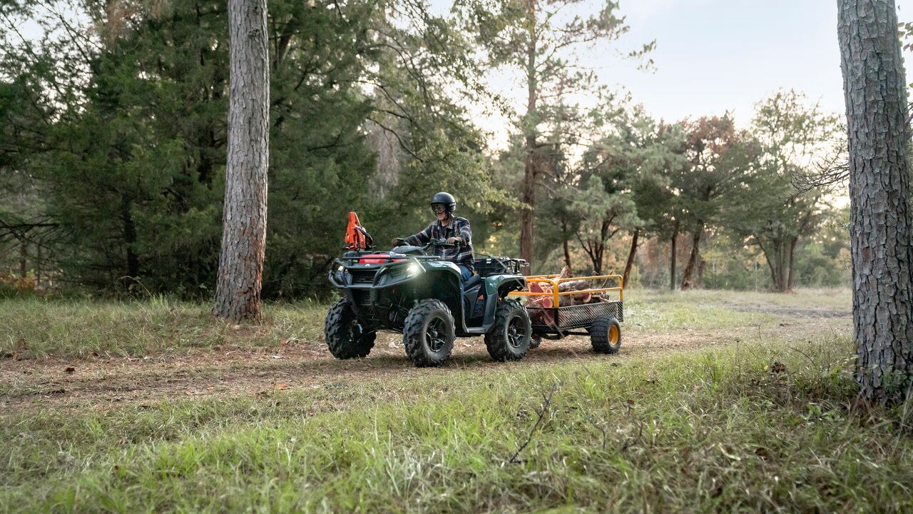 A man riding an Outlander with a trailer