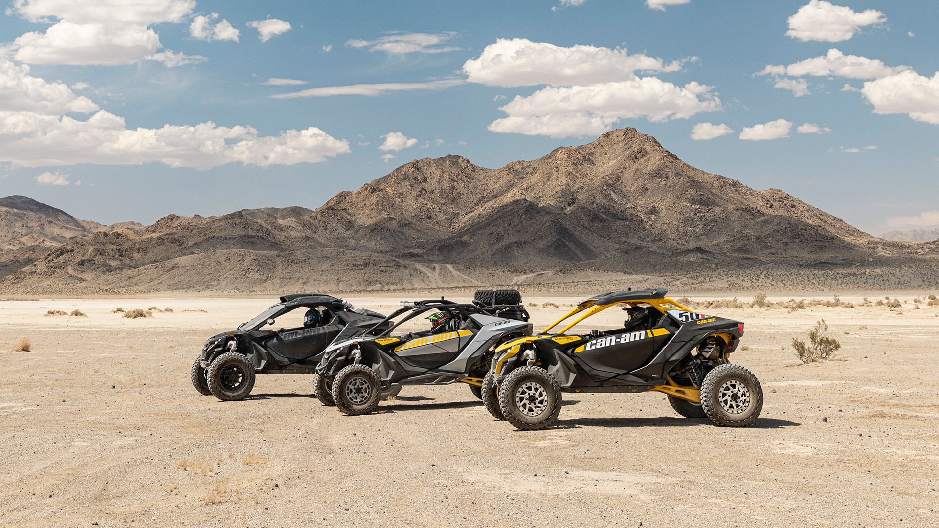 Man driving a Can-Am Maverick R in the sand