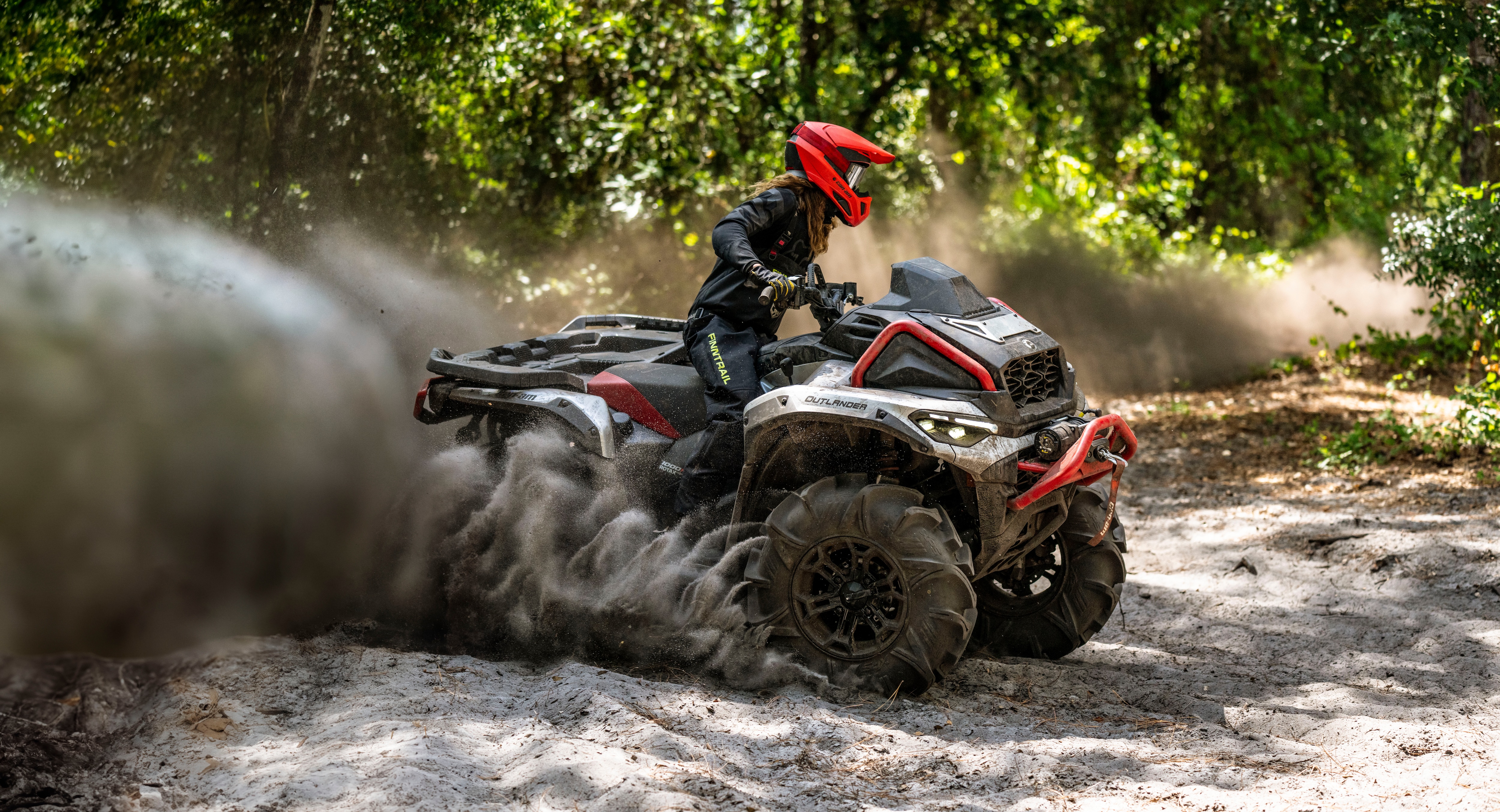A group of riders taking a break in the desert next to their Can-Am ATV and SxS vehicles