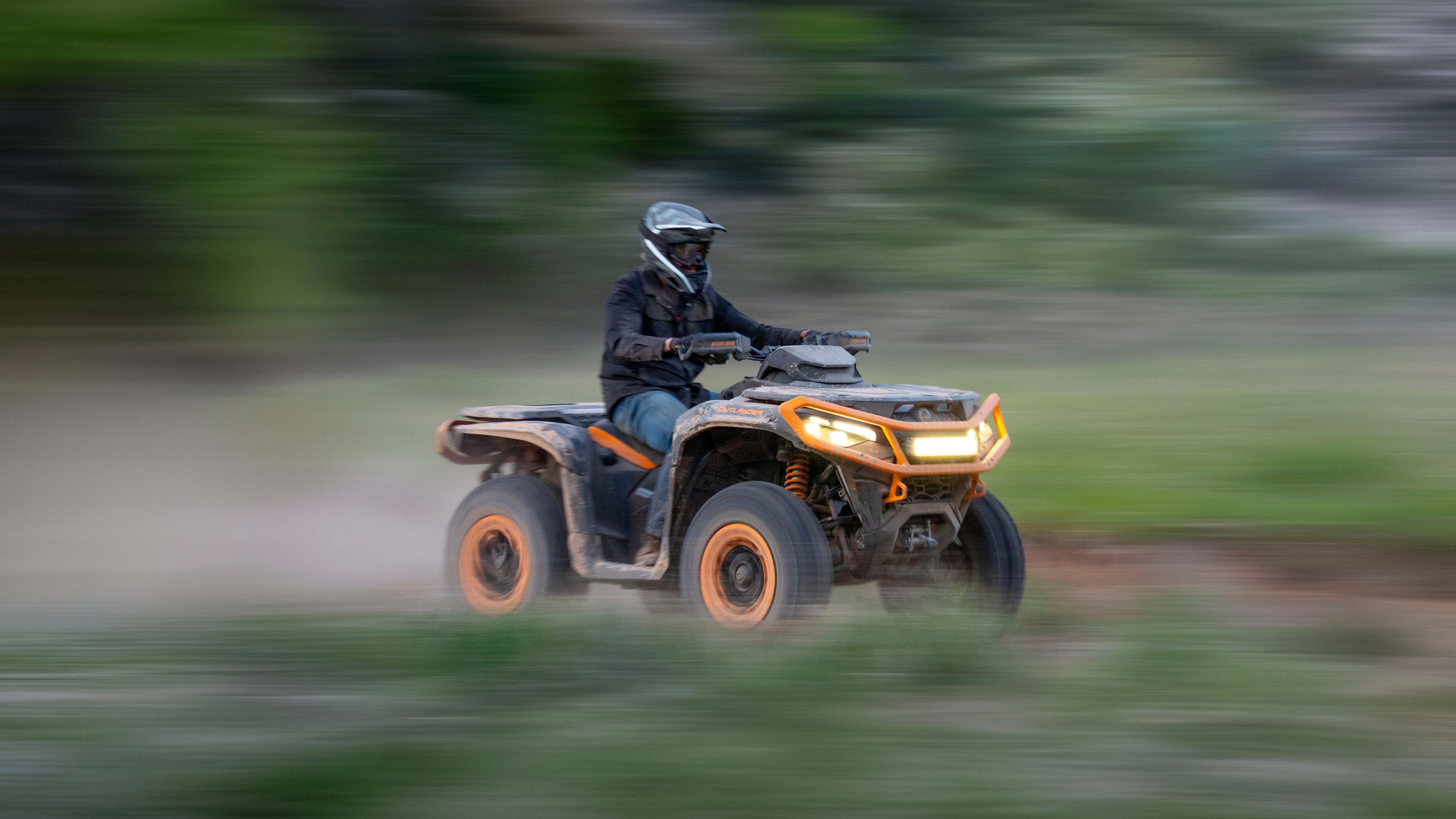 The Can-Am Outlander XT 1000R 2025 quad at full speed in the forest