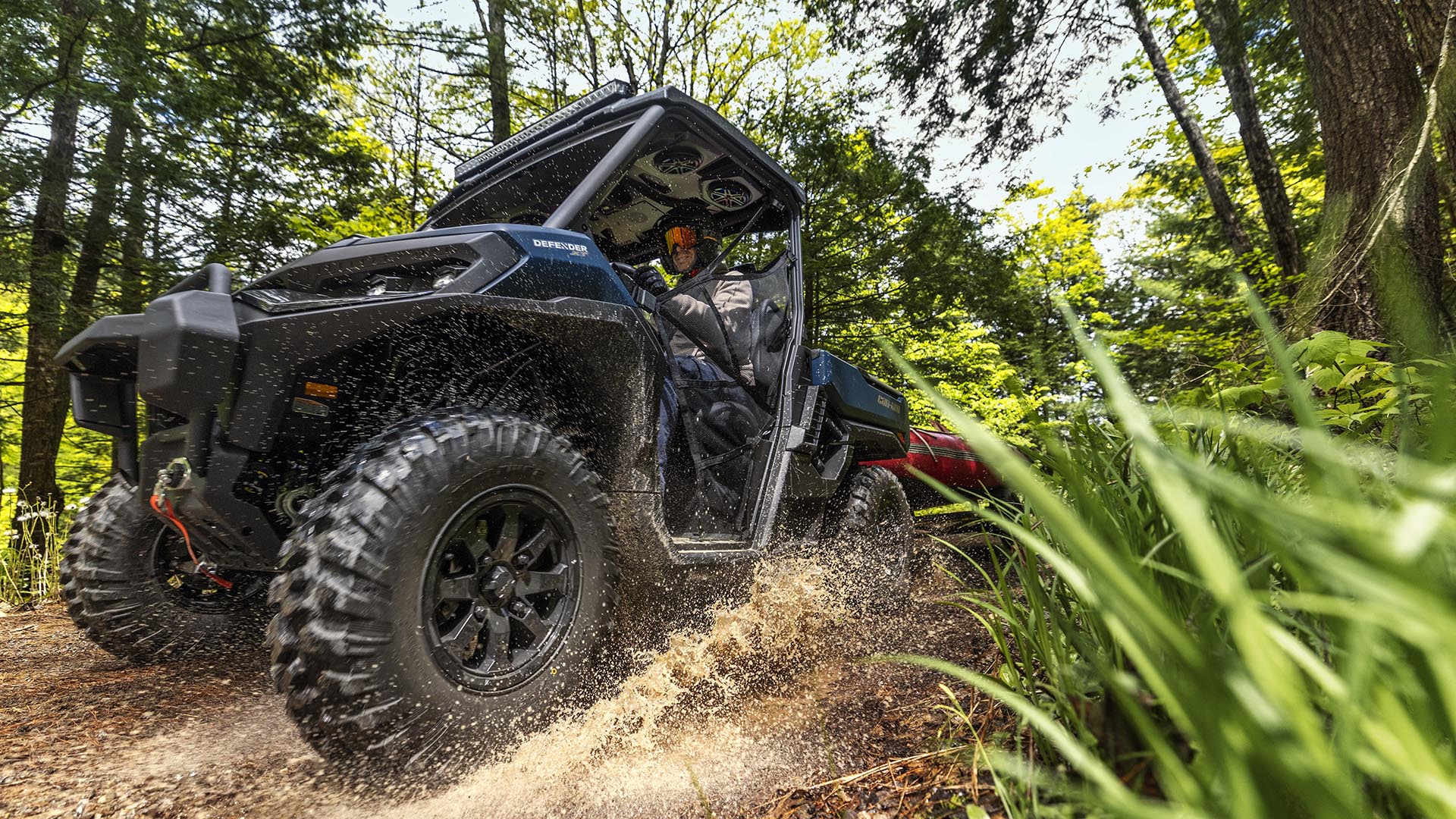 A Can-Am Traxter utility Side-by-Side utility emptying its cargo of rock