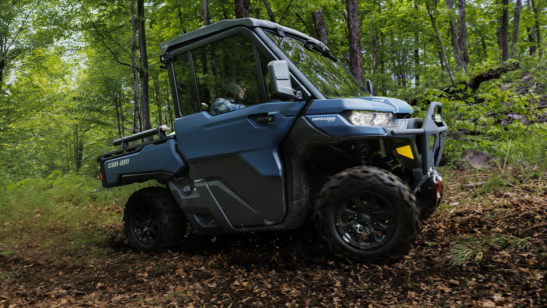 Front view of Can-Am traxter Max Lone Star Cab on a forest background