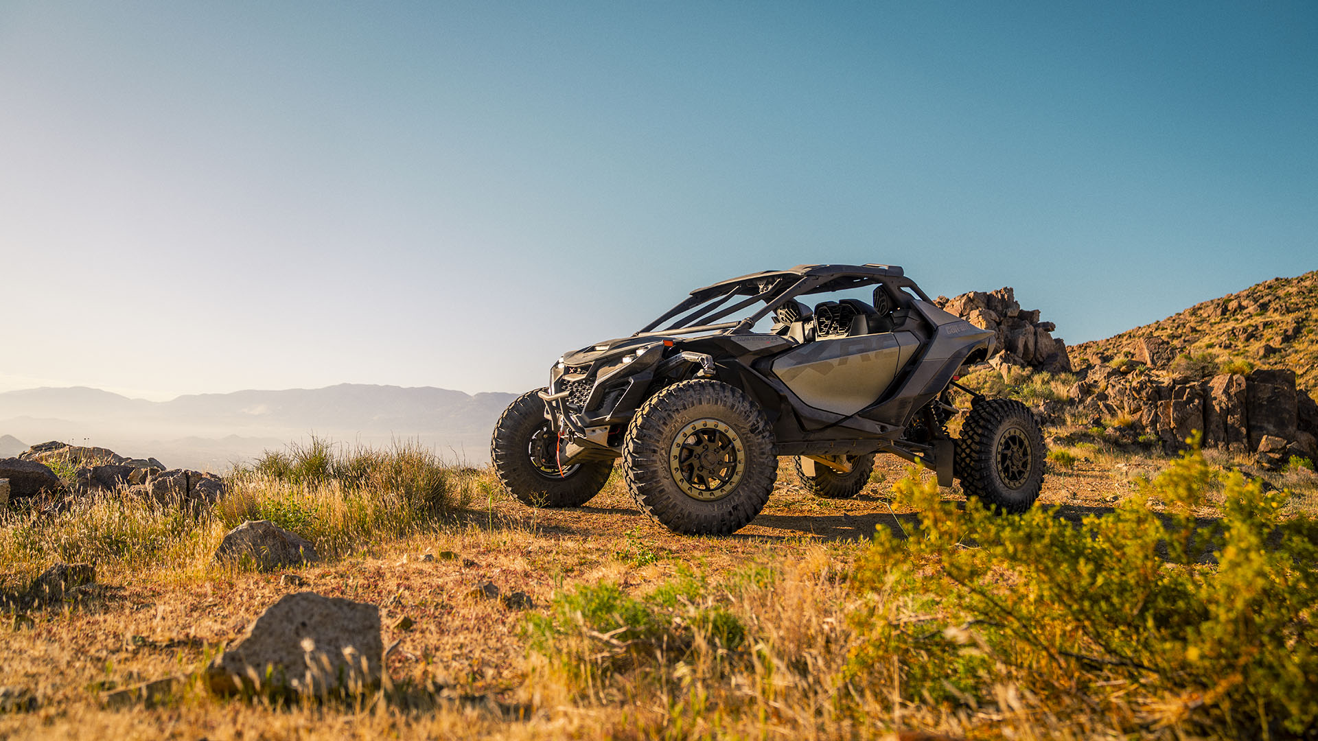 2026 Can-Am Maverick X RC side-by-side parked in an arid landscape