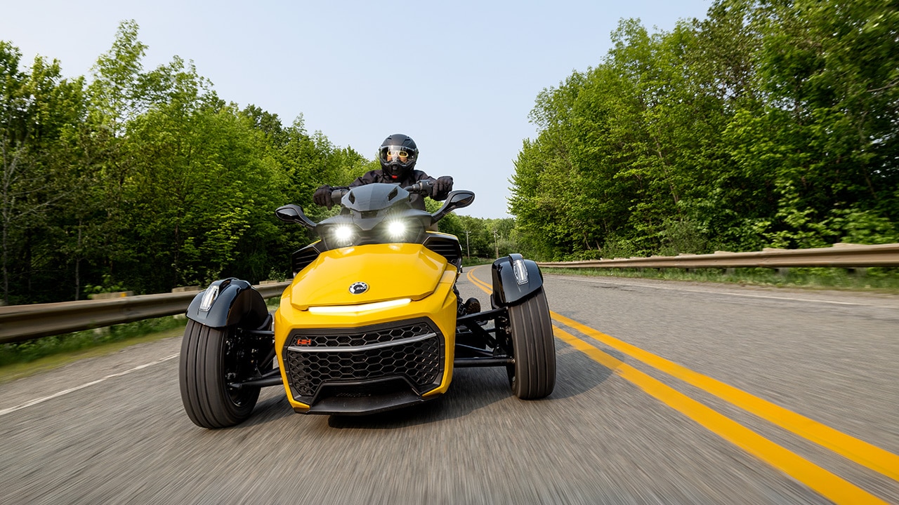 Woman riding a Can-Am Spyder F3 followed by two other riders