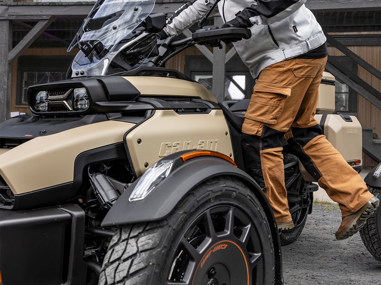 Rider about to sit on the 2027 Can-Am Canyon 3-wheel motorcycle